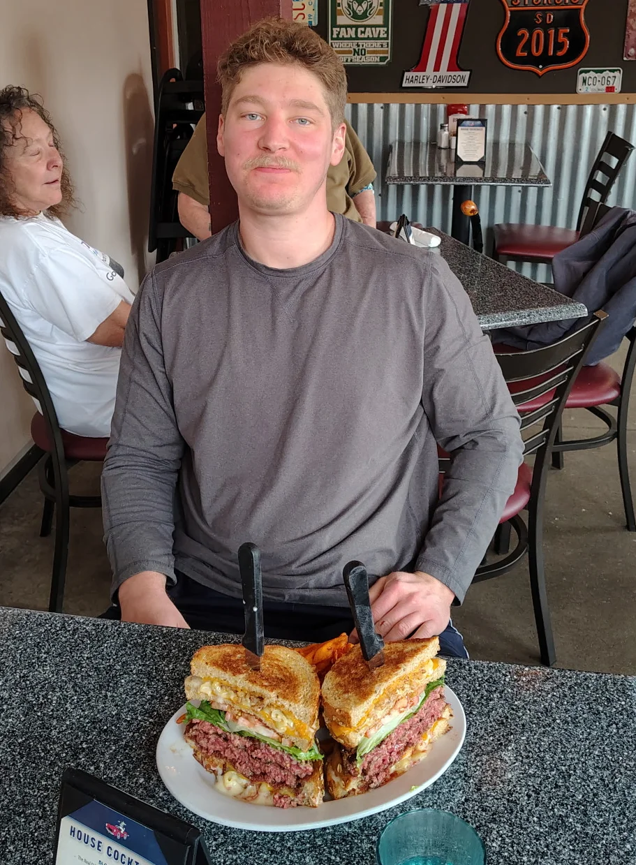 Giant cheeseburger with fries in a casual dining setting
