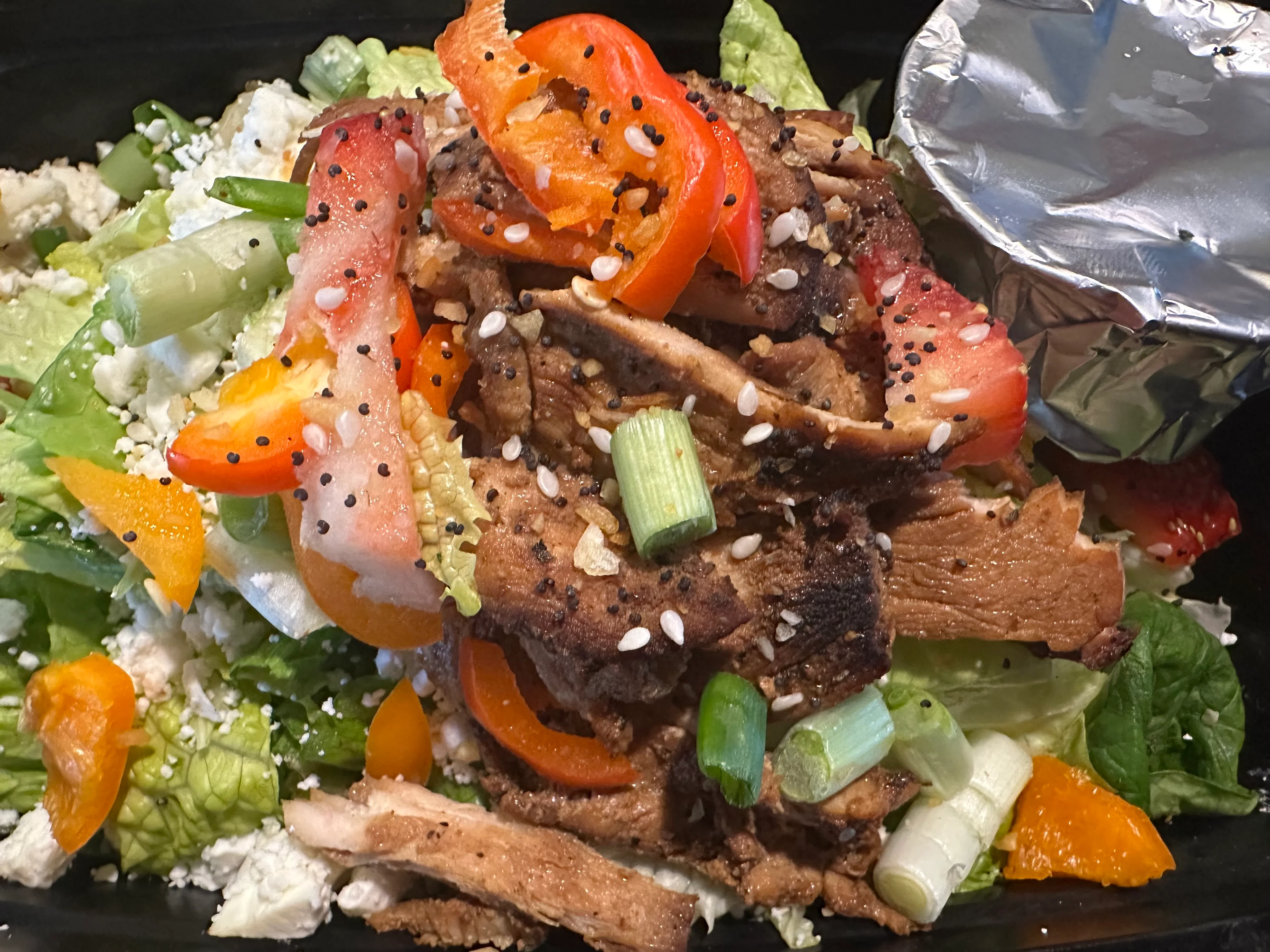 Asian-inspired chicken salad bowl with fresh vegetables