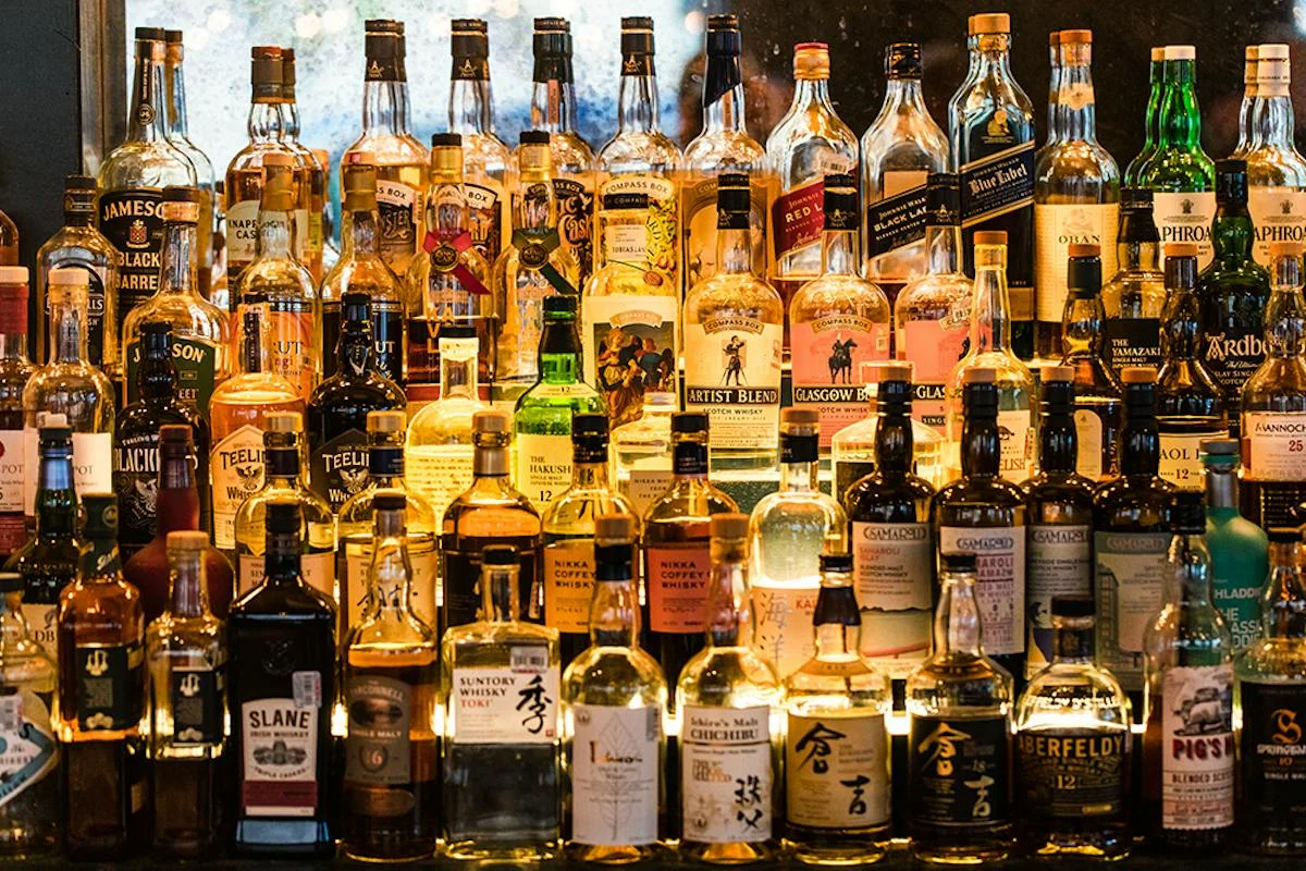 Well-stocked whiskey bar display with diverse whisky bottles
