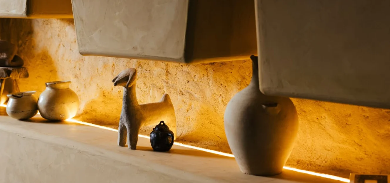 Artistic display of pottery and decor in a cozy restaurant interior