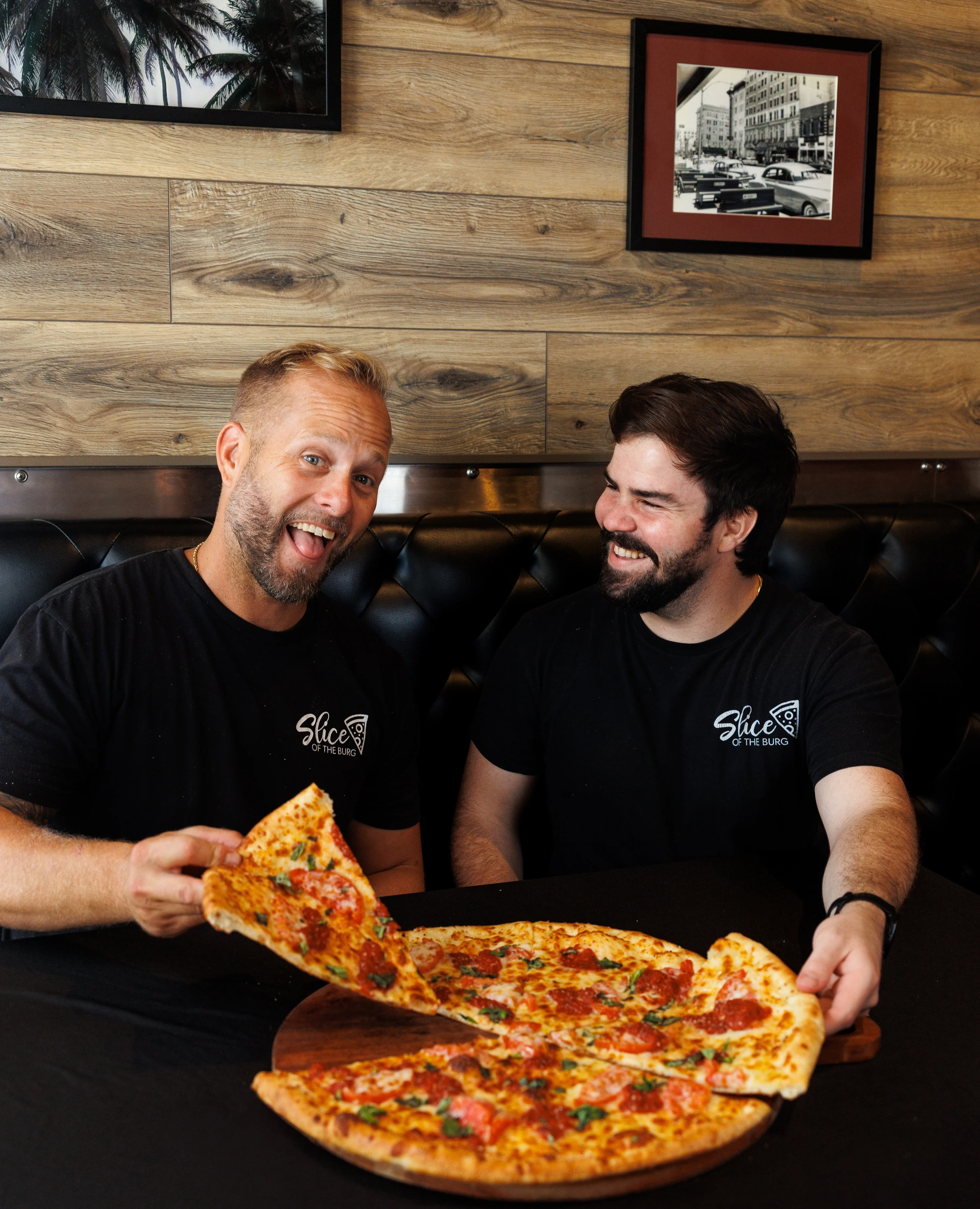 Slice of the Burg owners enjoying a delicious pizza together