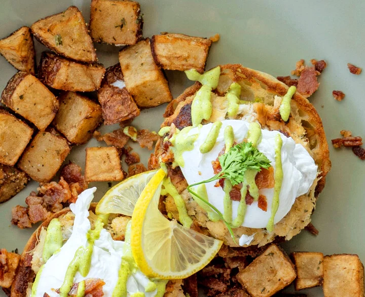 Eggs Benedict with crispy potatoes on a plate