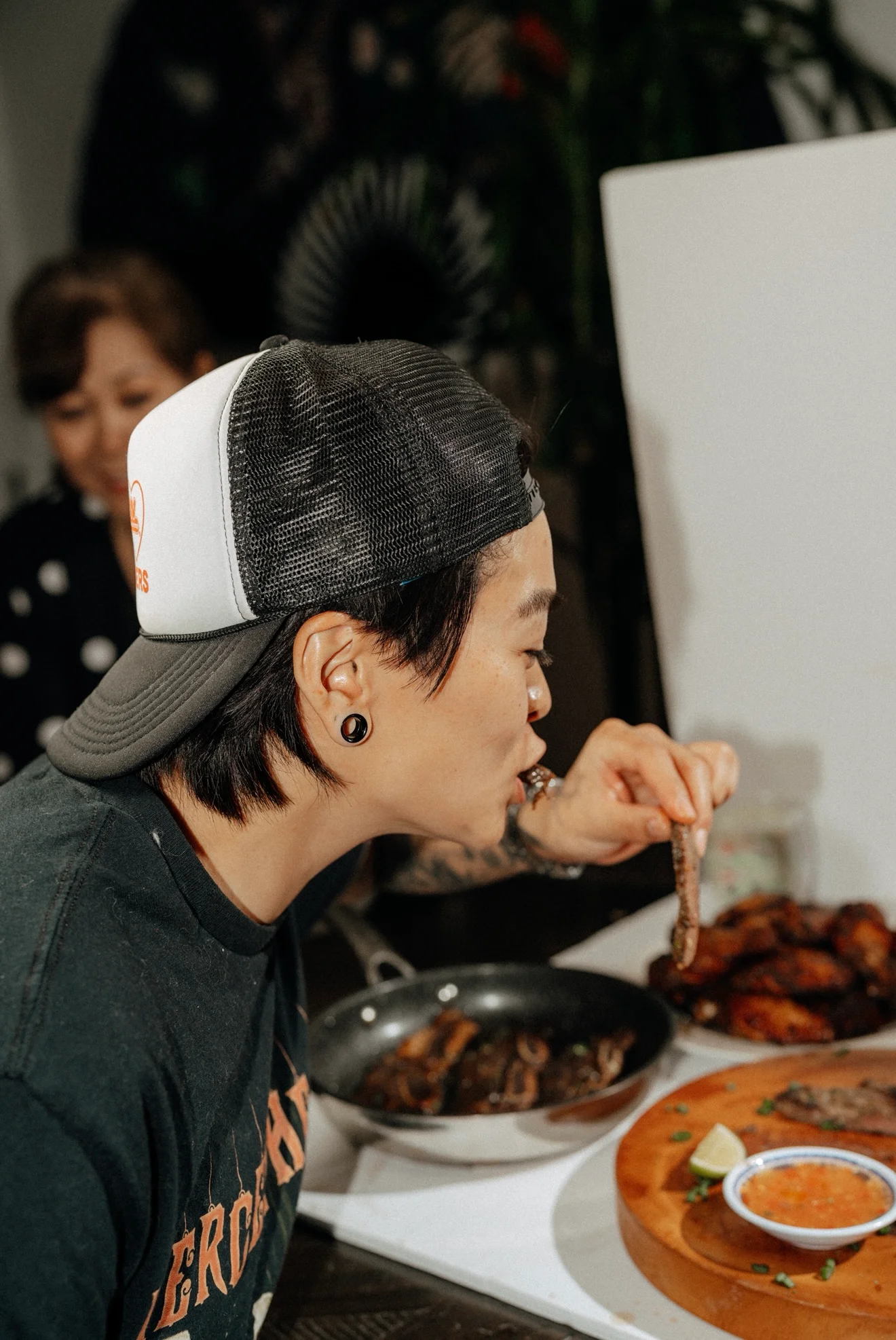 Person enjoying Korean BBQ with grilled meat
