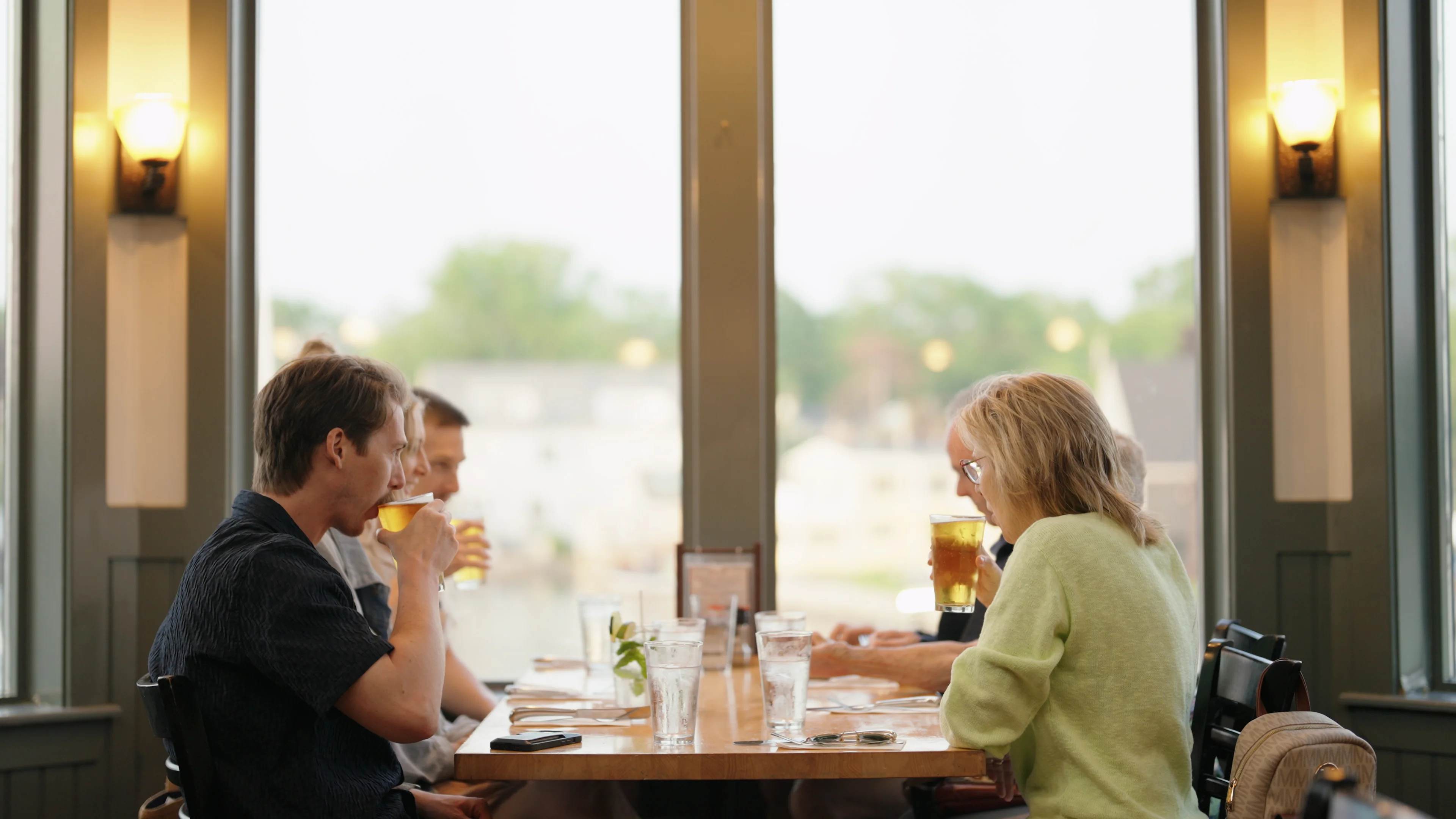 Group of friends enjoying drinks in a cozy restaurant setting