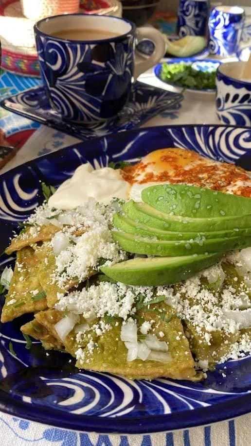 Chilaquiles verdes topped with avocado and fried egg