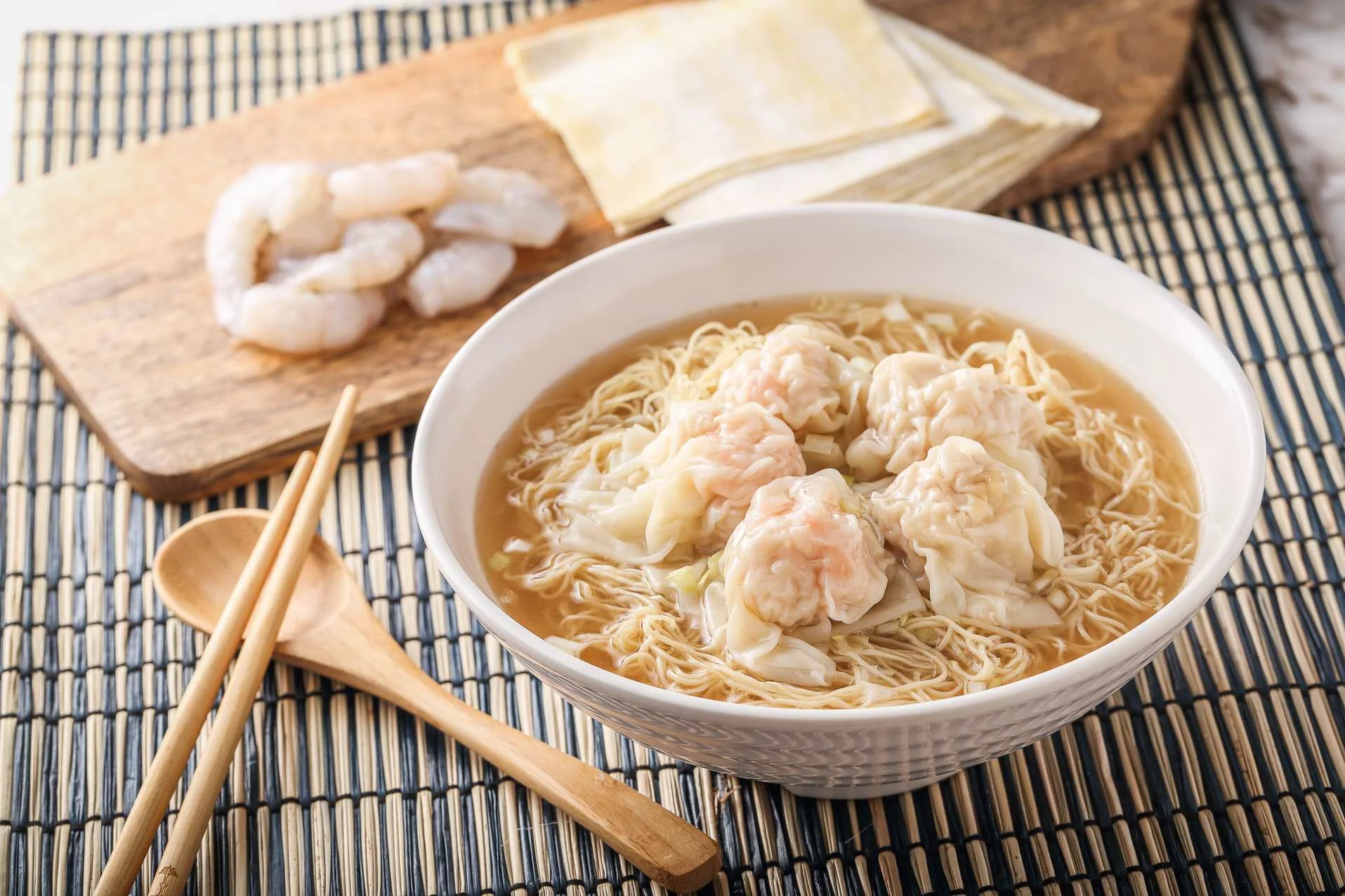 Delicious bowl of Chinese wonton noodle soup with shrimp dumplings