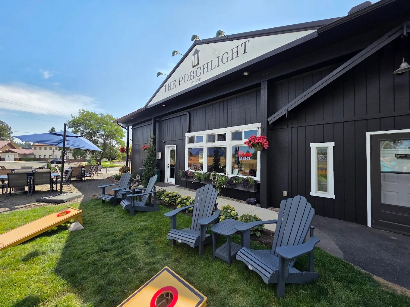 Charming restaurant exterior with outdoor seating and greenery