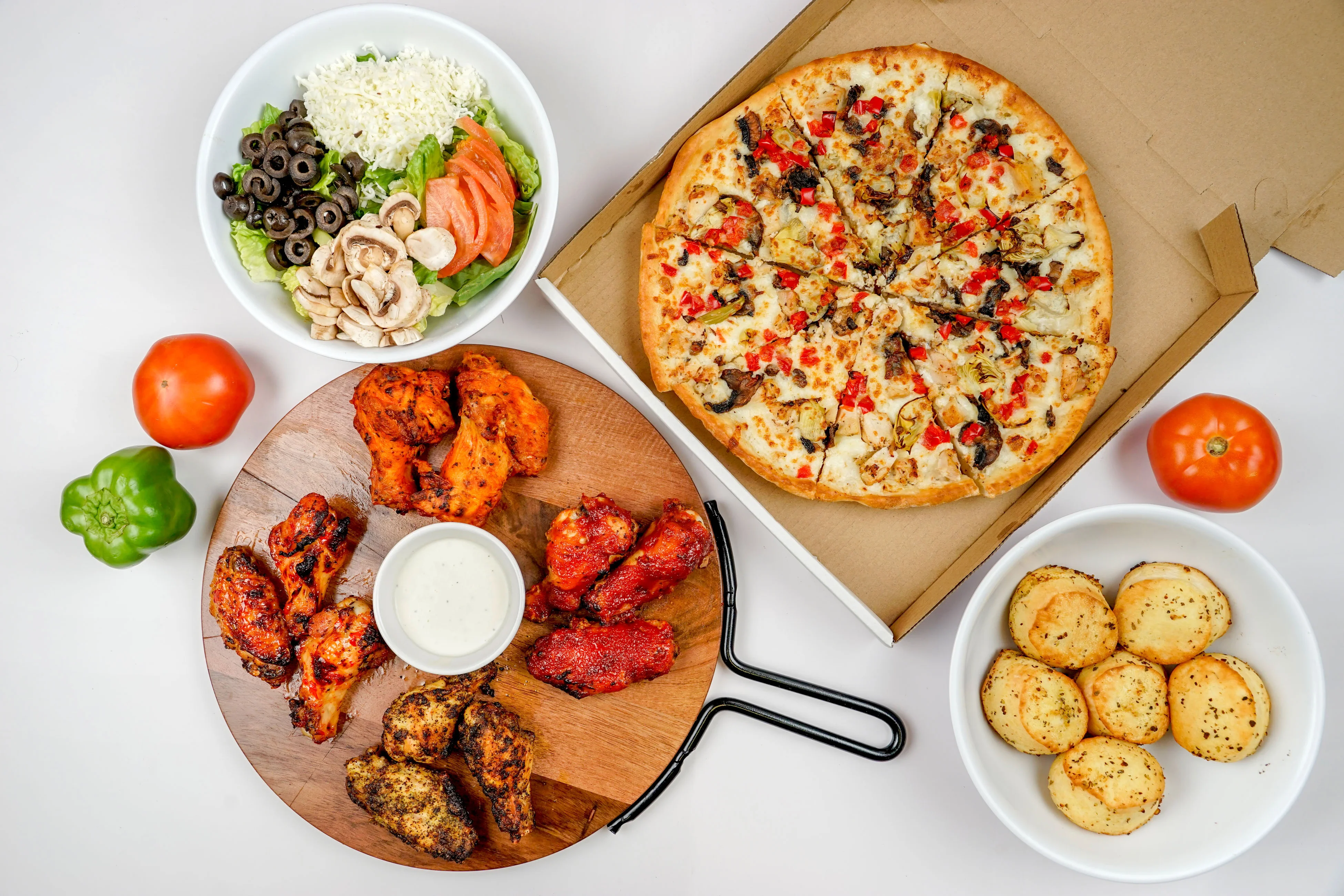 Delicious pizza with wings and salad, perfect for a casual meal