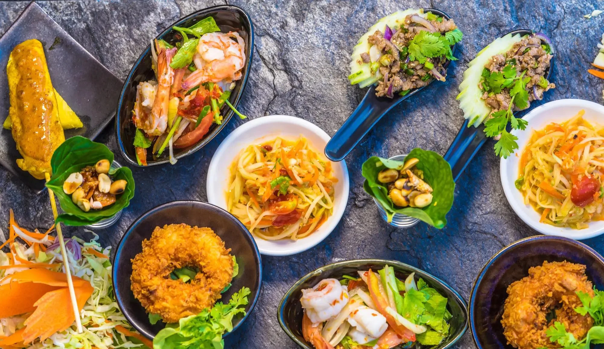 Assorted Thai appetizers including papaya salad and shrimp dishes
