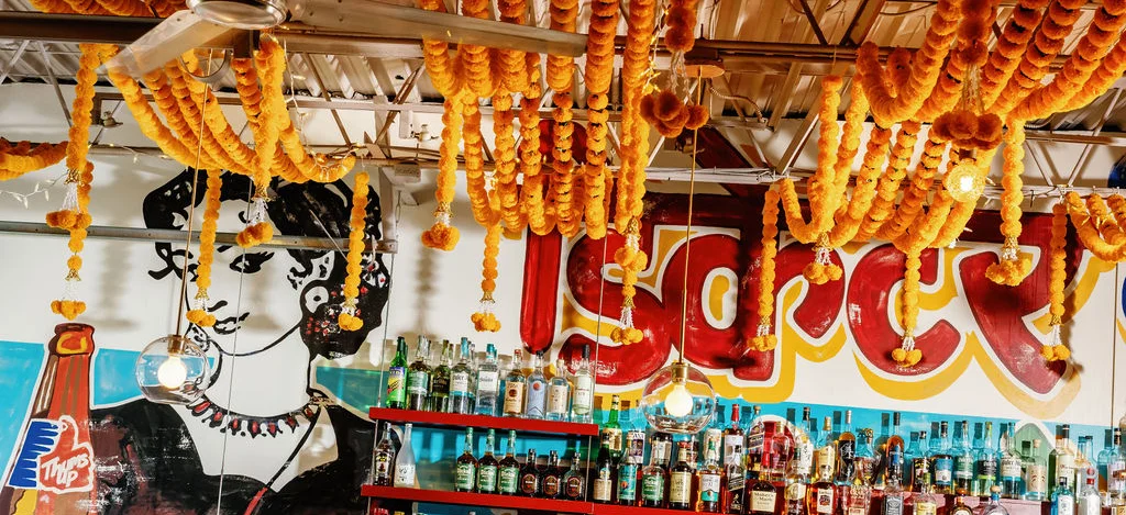 Vibrant restaurant interior with floral decor and lively atmosphere