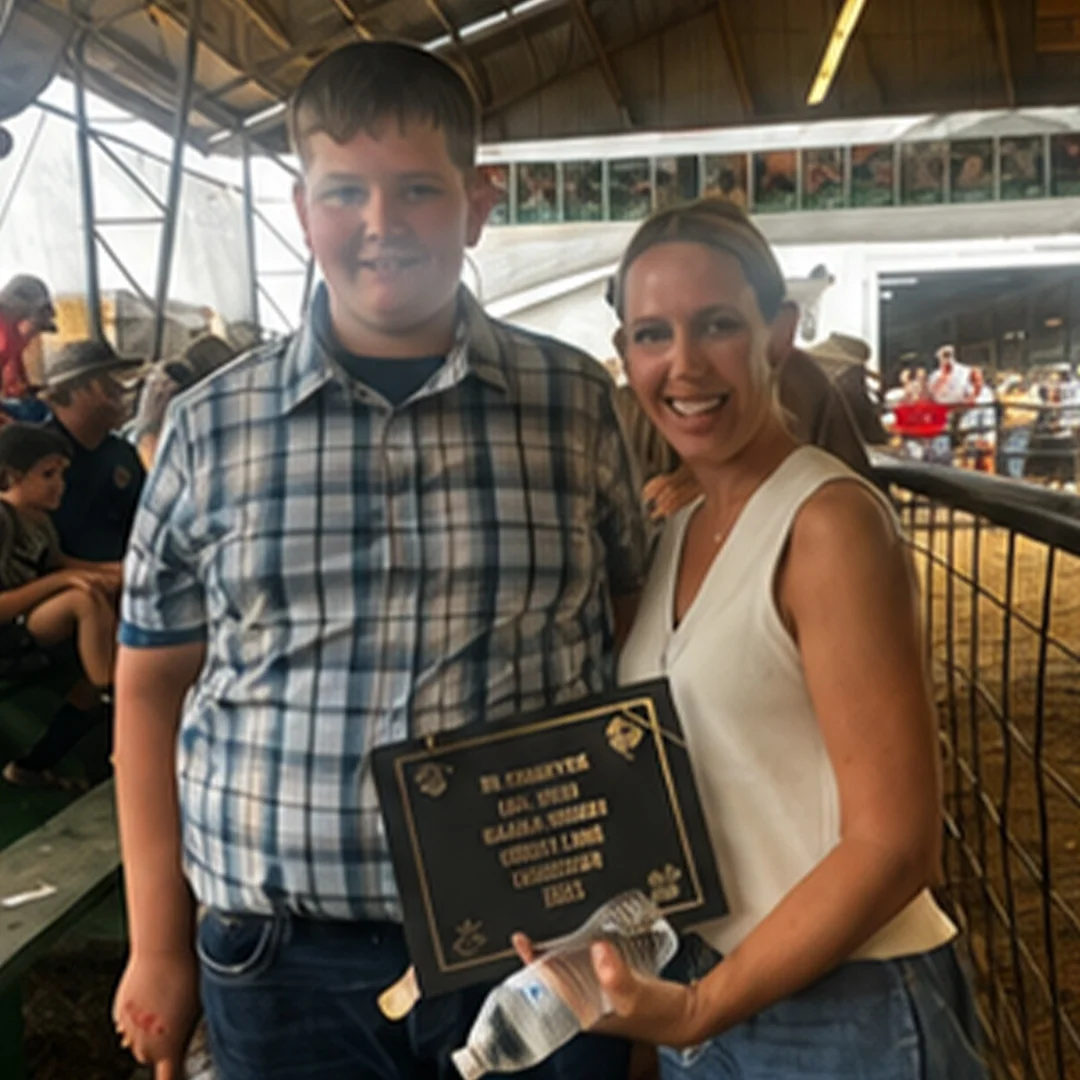 Two people celebrating an award at a fair event