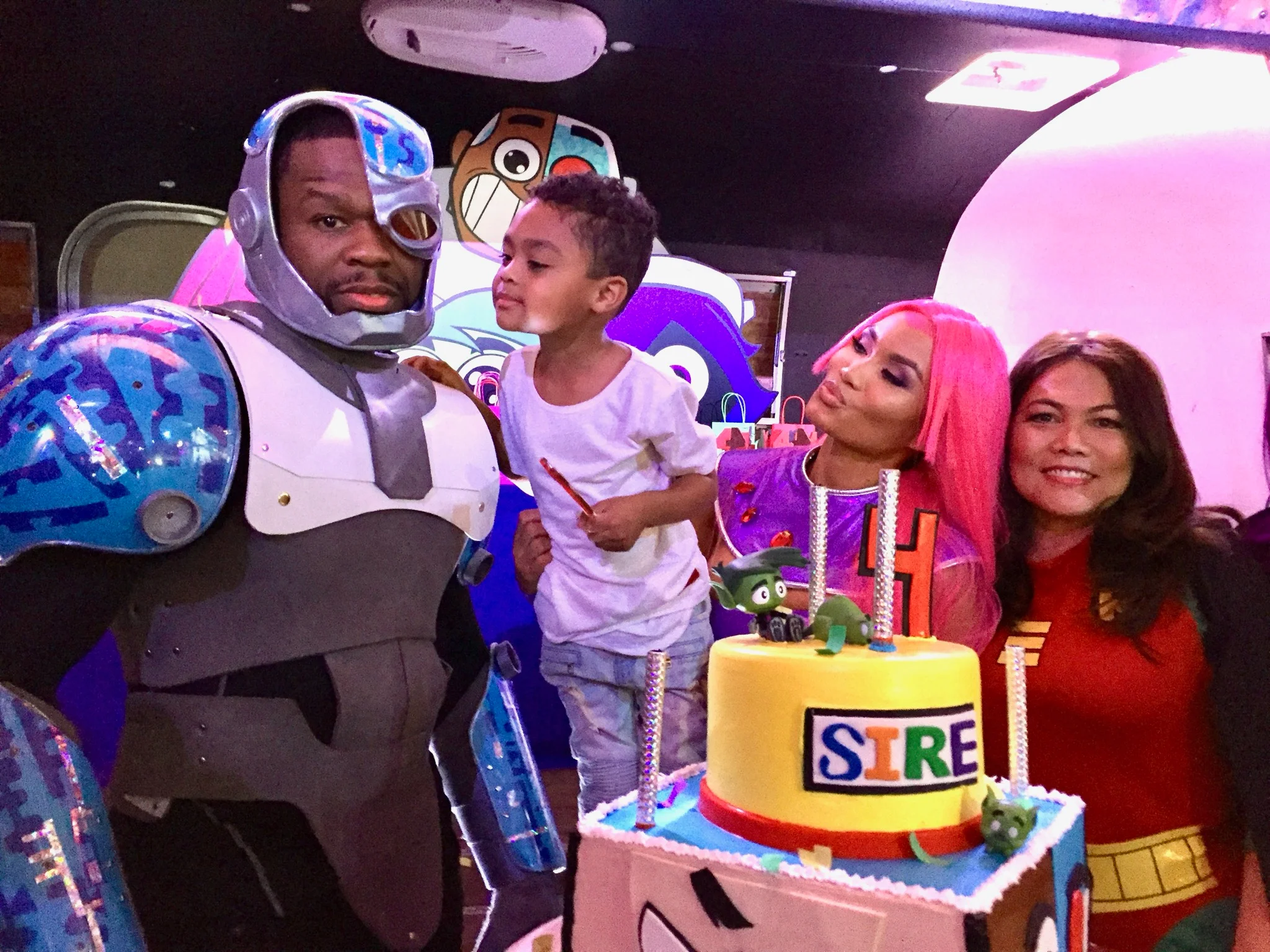 Children's birthday party with superhero theme and colorful cake