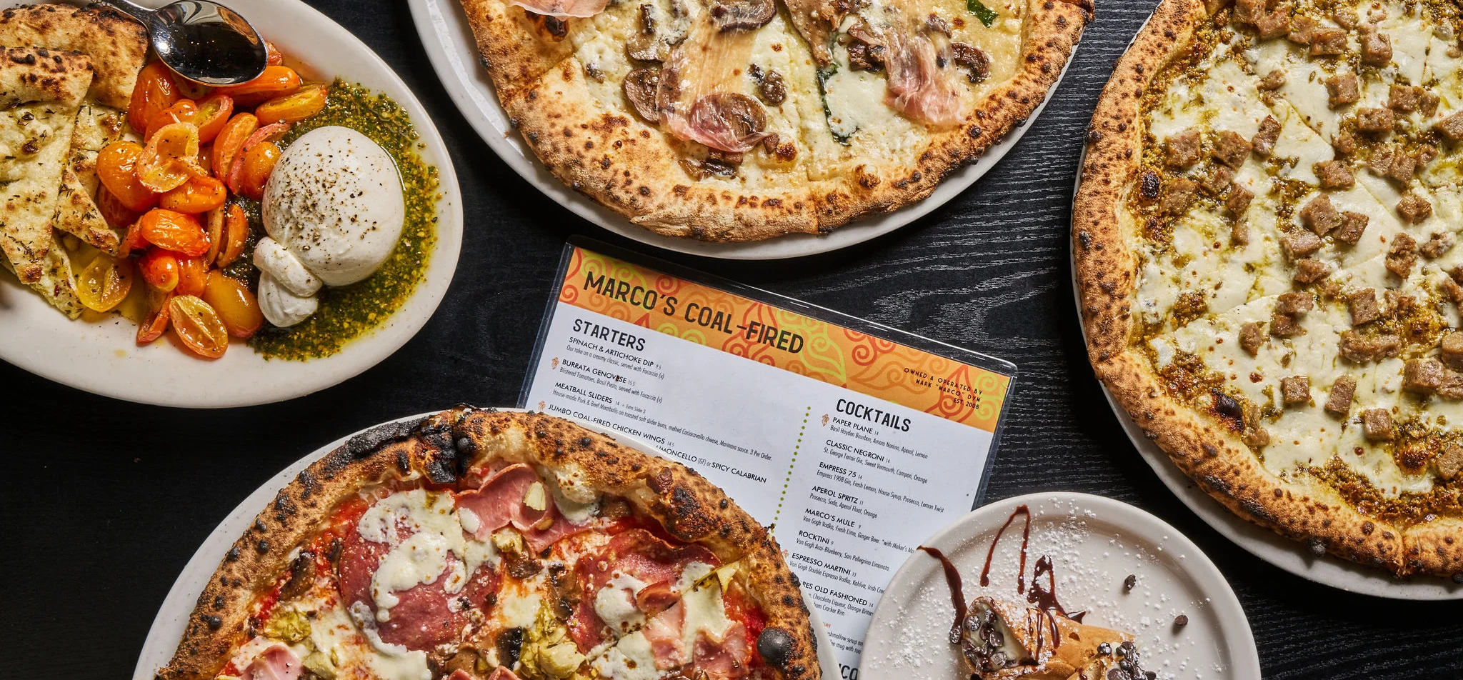 Assorted coal-fired pizzas and burrata appetizer