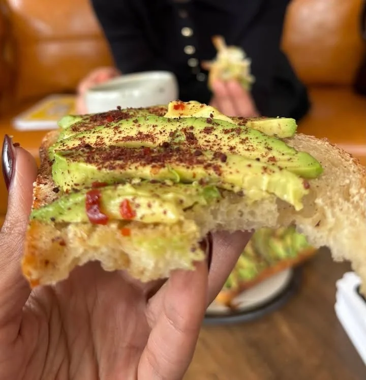 Avocado toast with spices in a cozy café setting