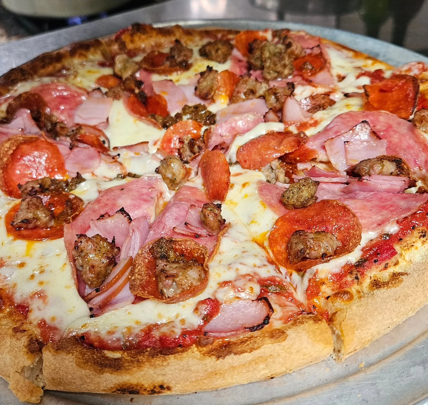 Loaded meat lover's pizza with pepperoni and sausage