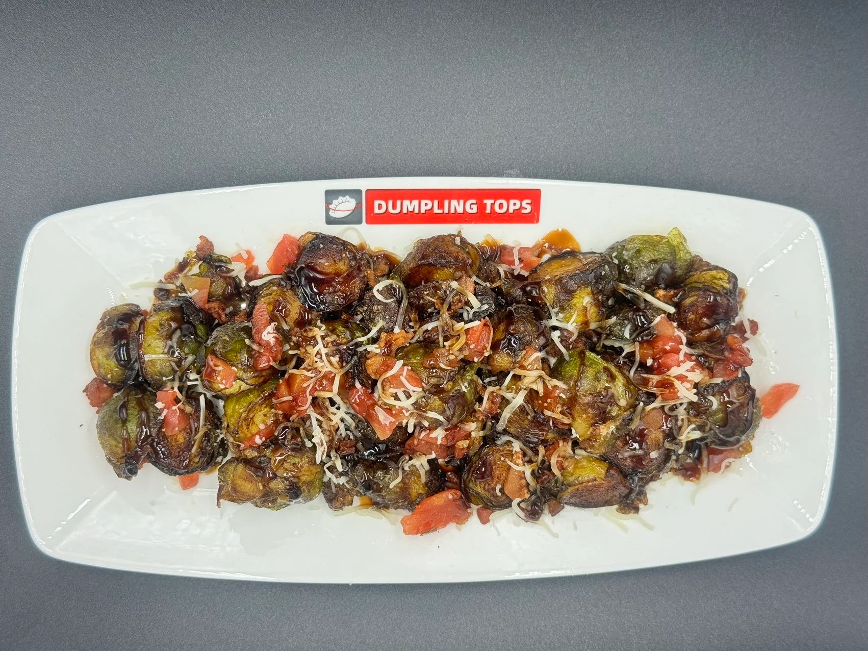 Crispy dumplings topped with fresh tomatoes and cheese