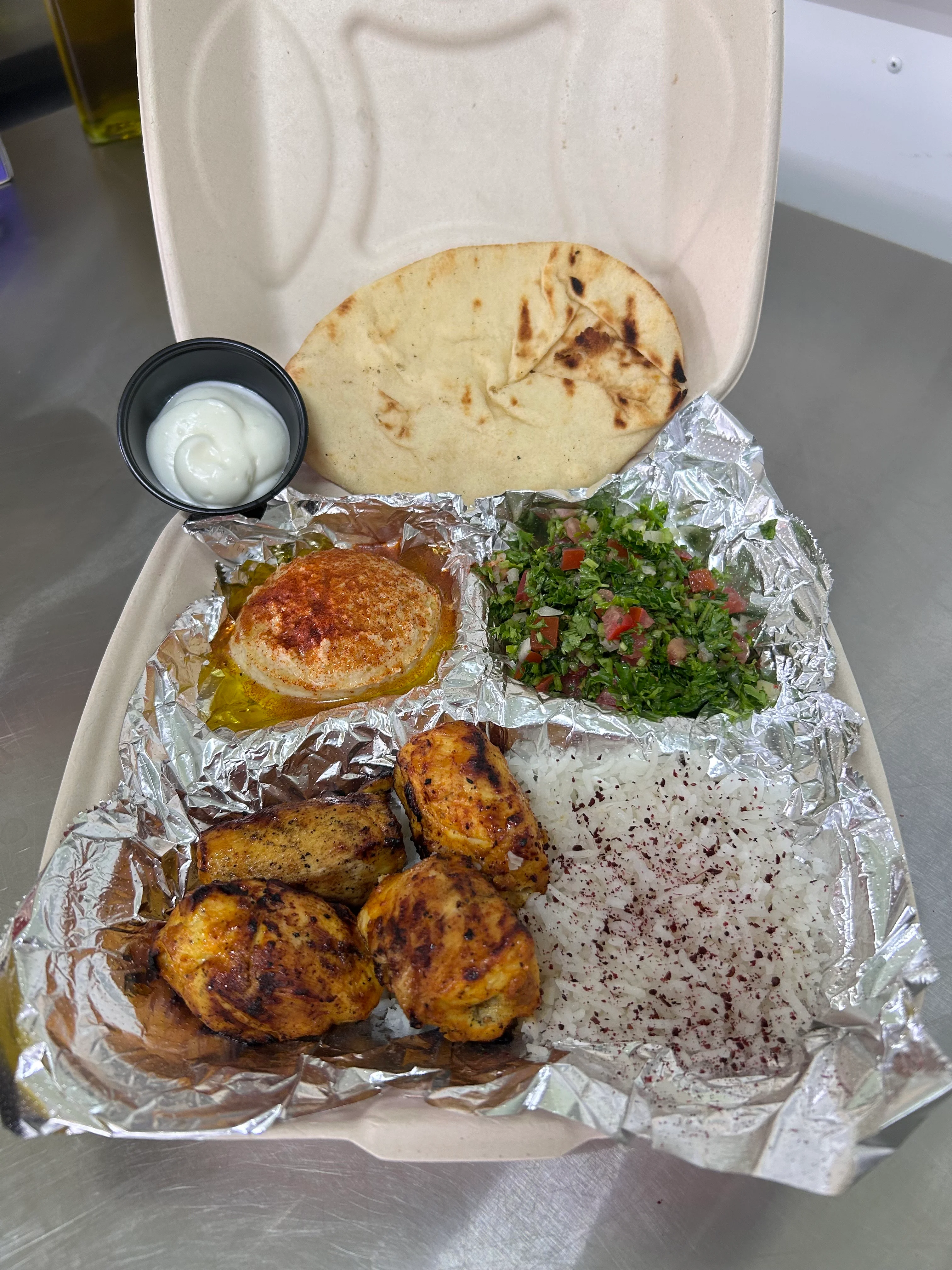 Grilled chicken platter with tabbouleh and pita bread