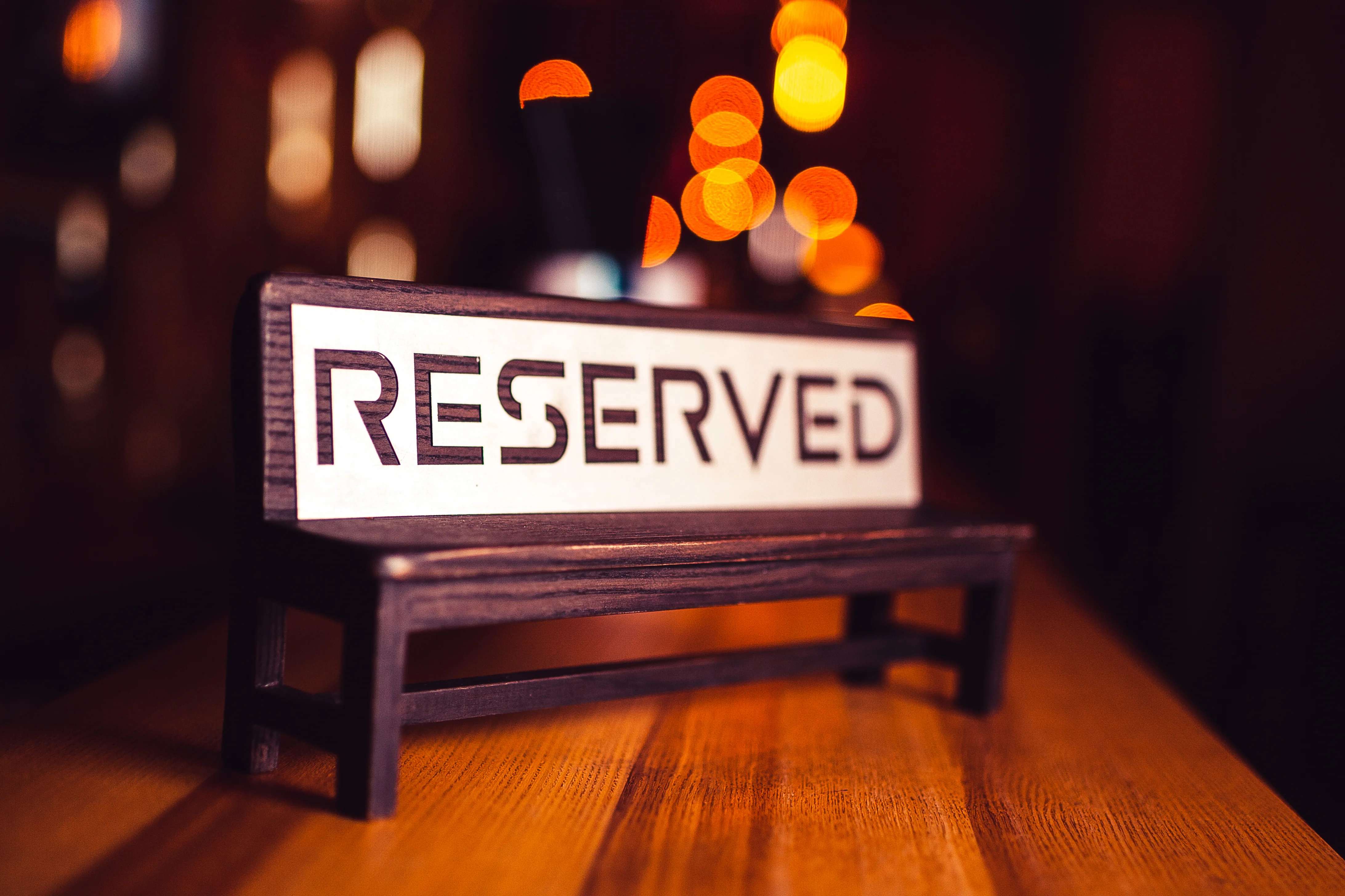 Reserved sign on a wooden table in a cozy restaurant setting