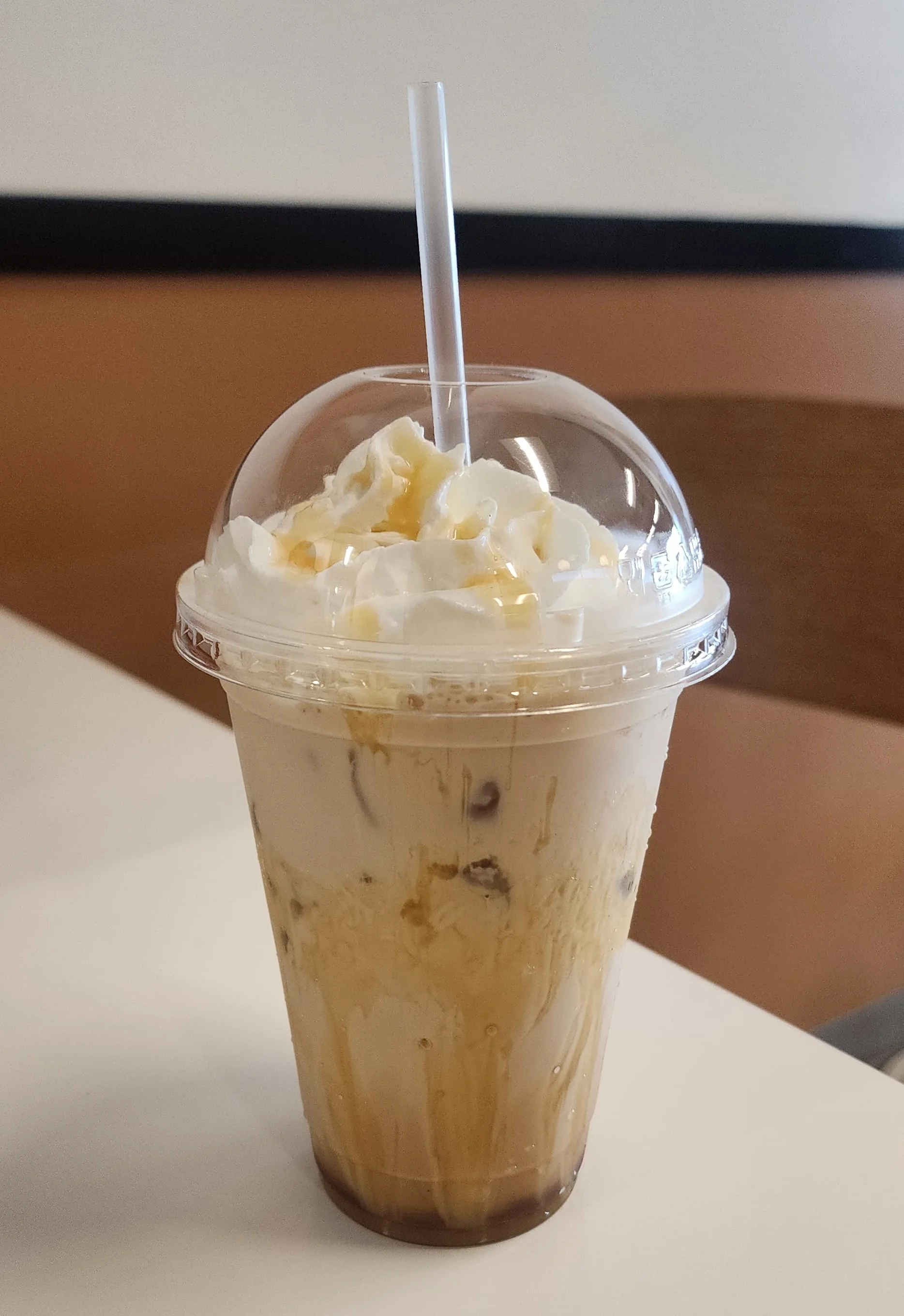 Iced caramel macchiato topped with whipped cream