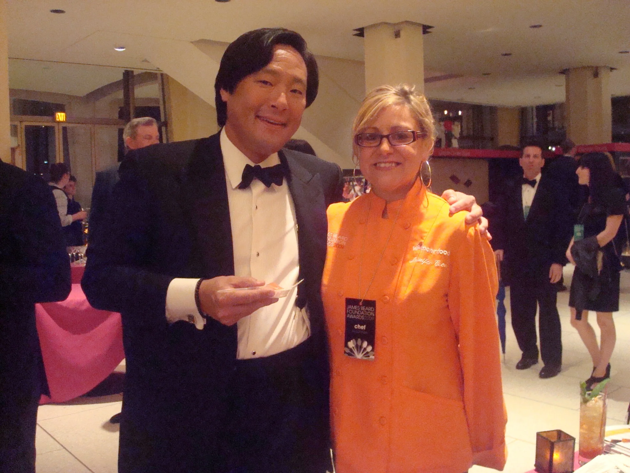 Two chefs posing at a culinary event in formal attire