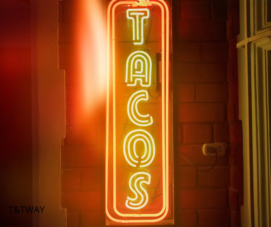 Bright neon sign for tacos in a vibrant restaurant setting