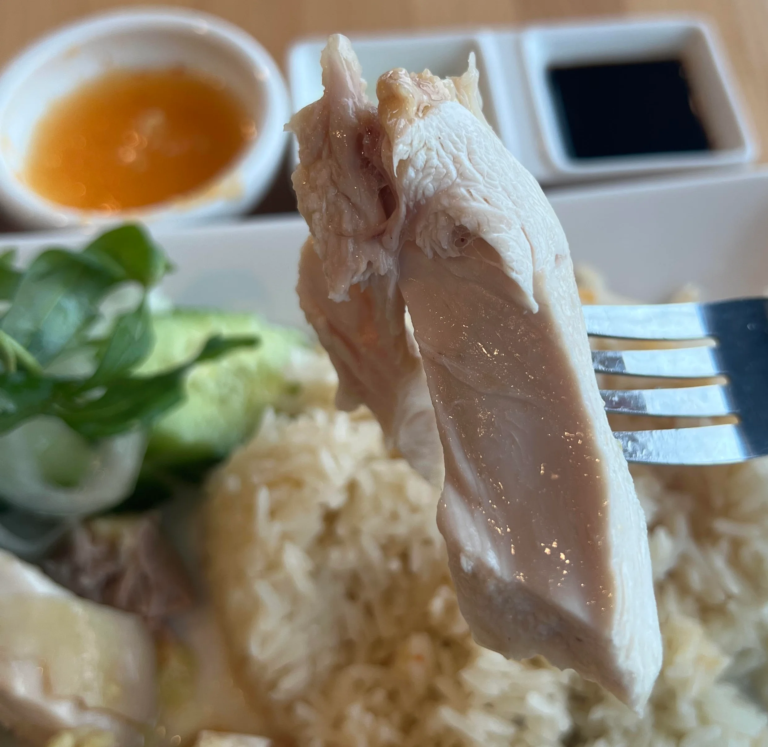 Hainanese chicken rice served with sauces