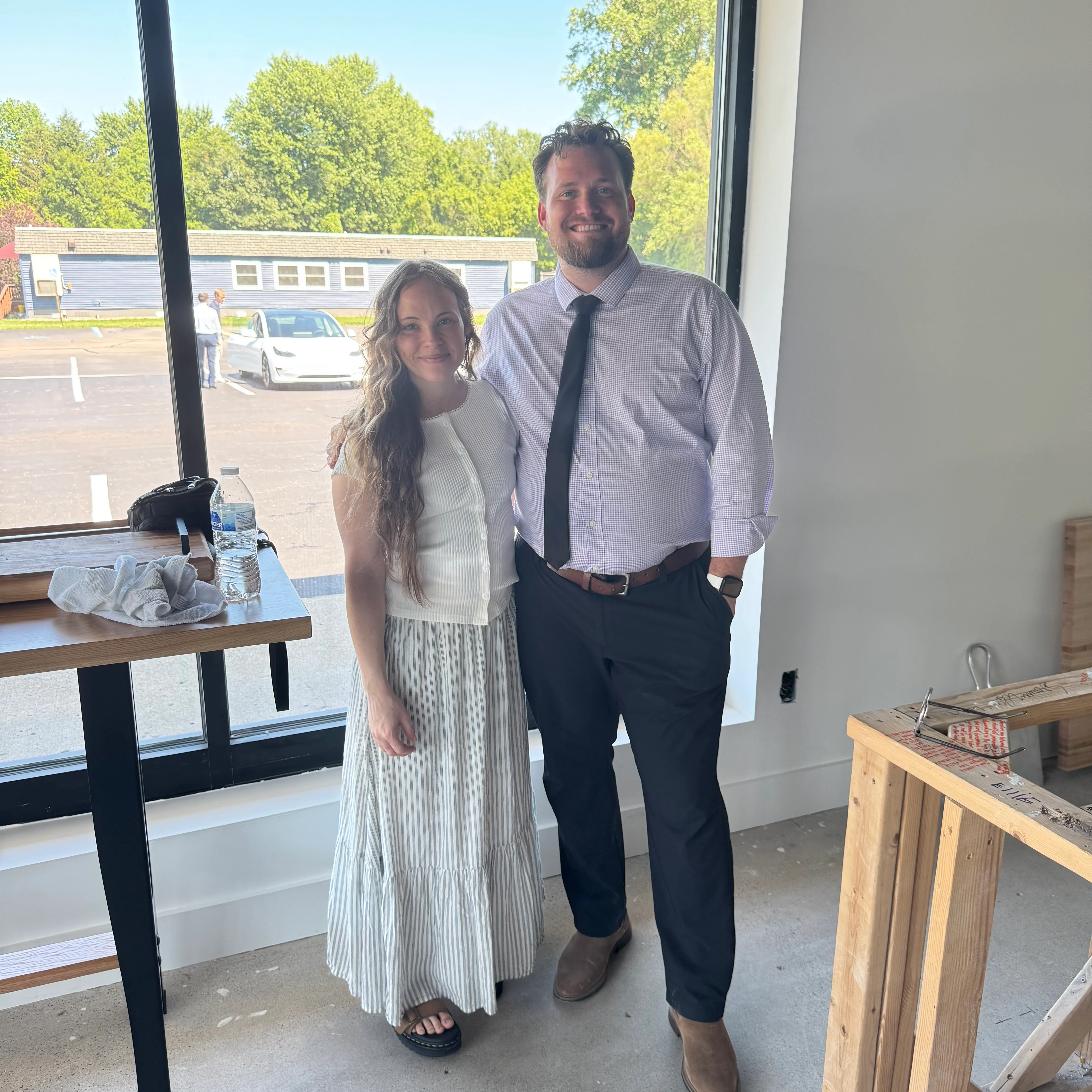 Two people posing in a modern restaurant interior
