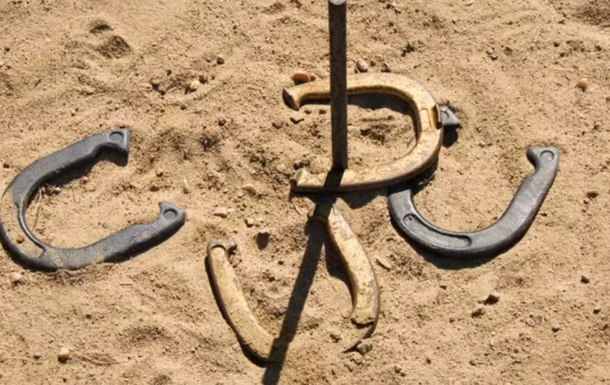 Horseshoes arranged in sand for a game