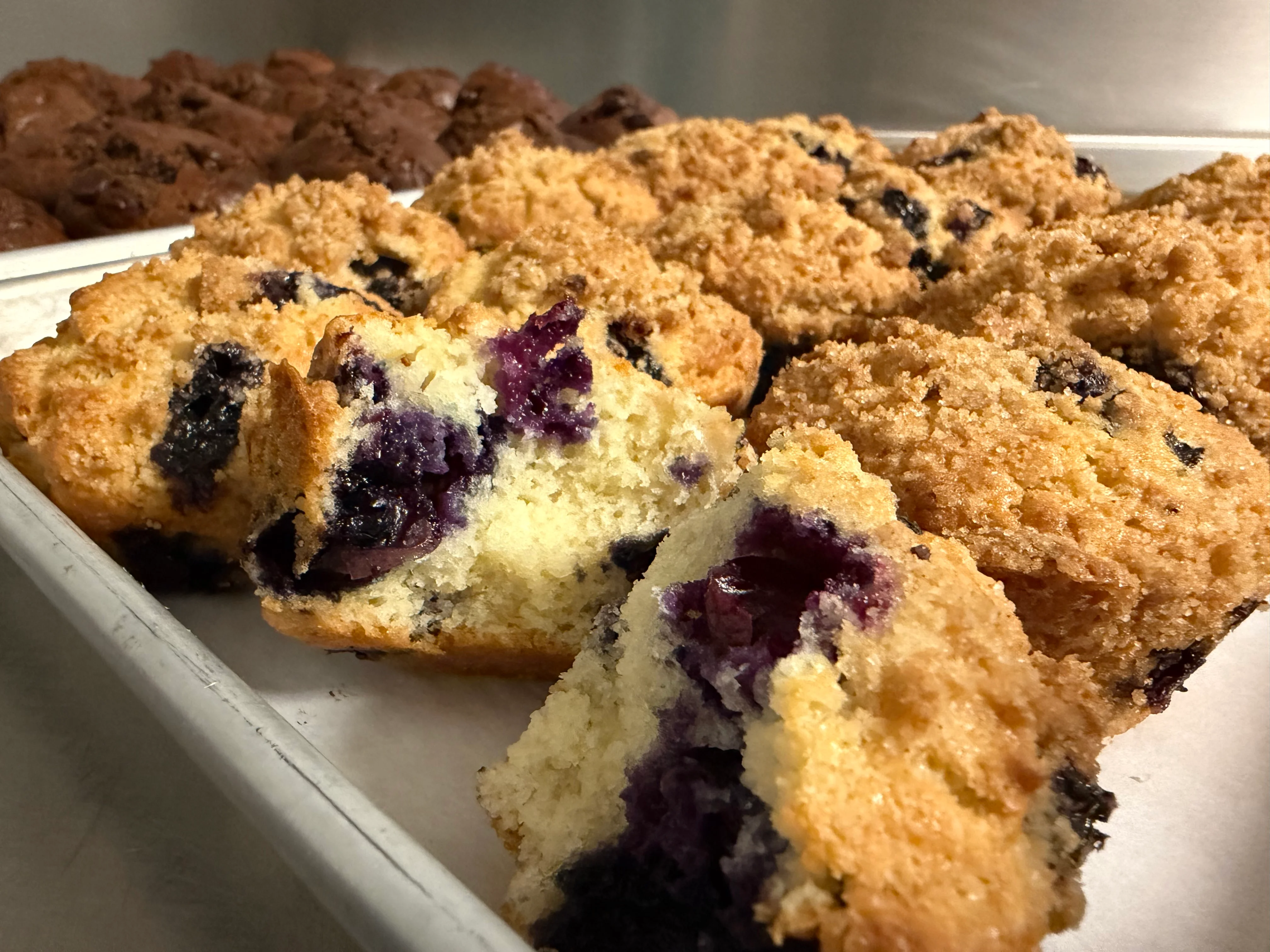 Freshly baked blueberry muffins on a tray