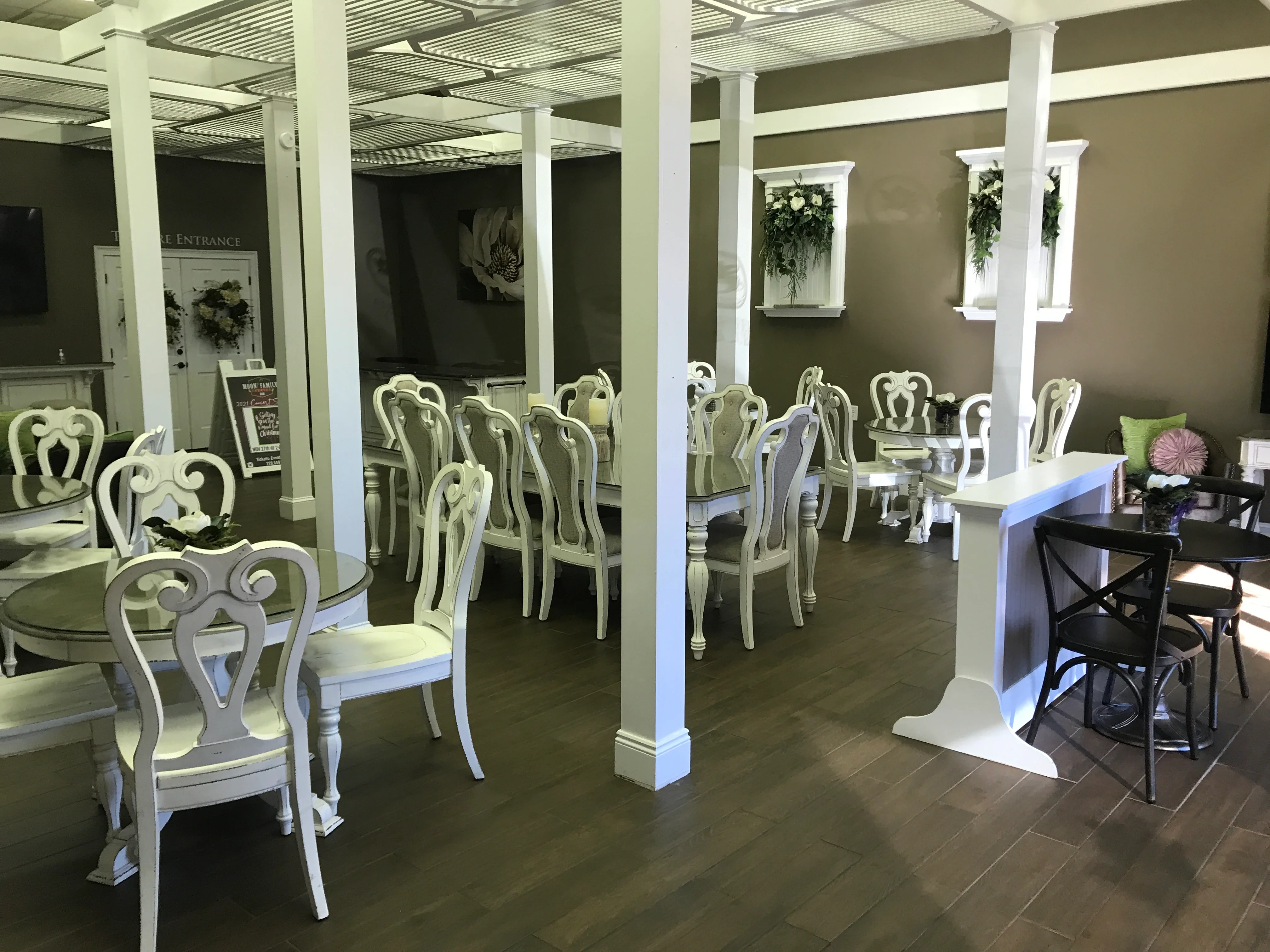 Elegant restaurant interior with white furniture and decorative plants