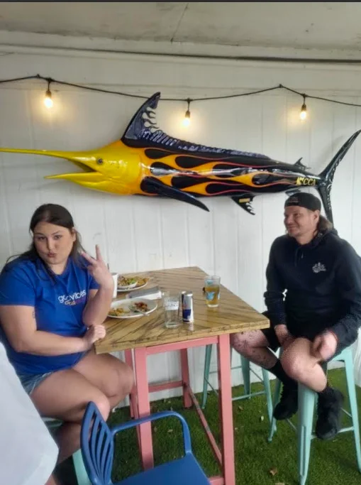 Cozy restaurant interior with colorful decor and a marlin sculpture