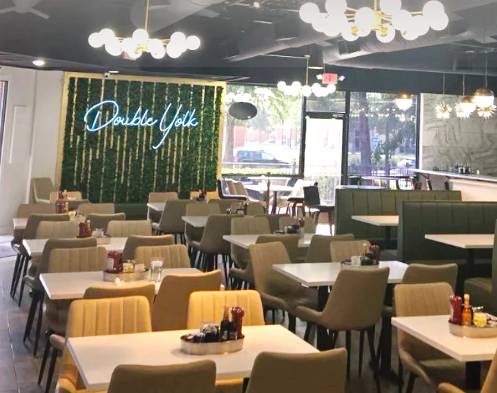 Modern café interior with stylish seating and greenery decor