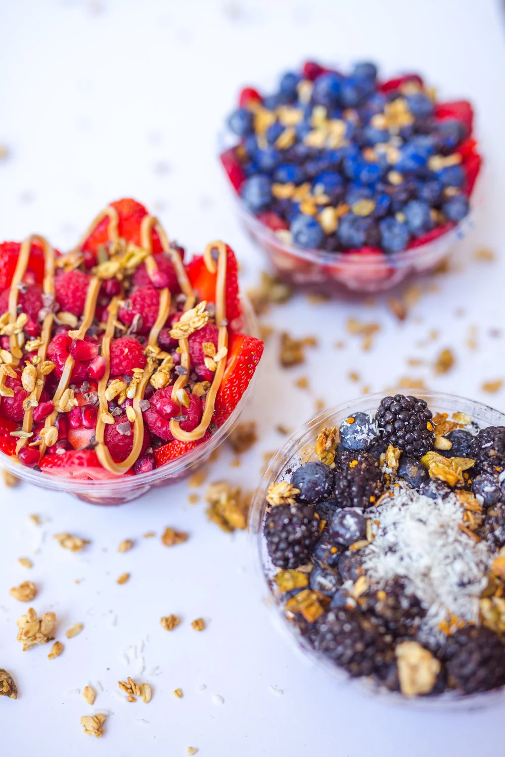 Colorful acai bowls topped with fresh berries and granola