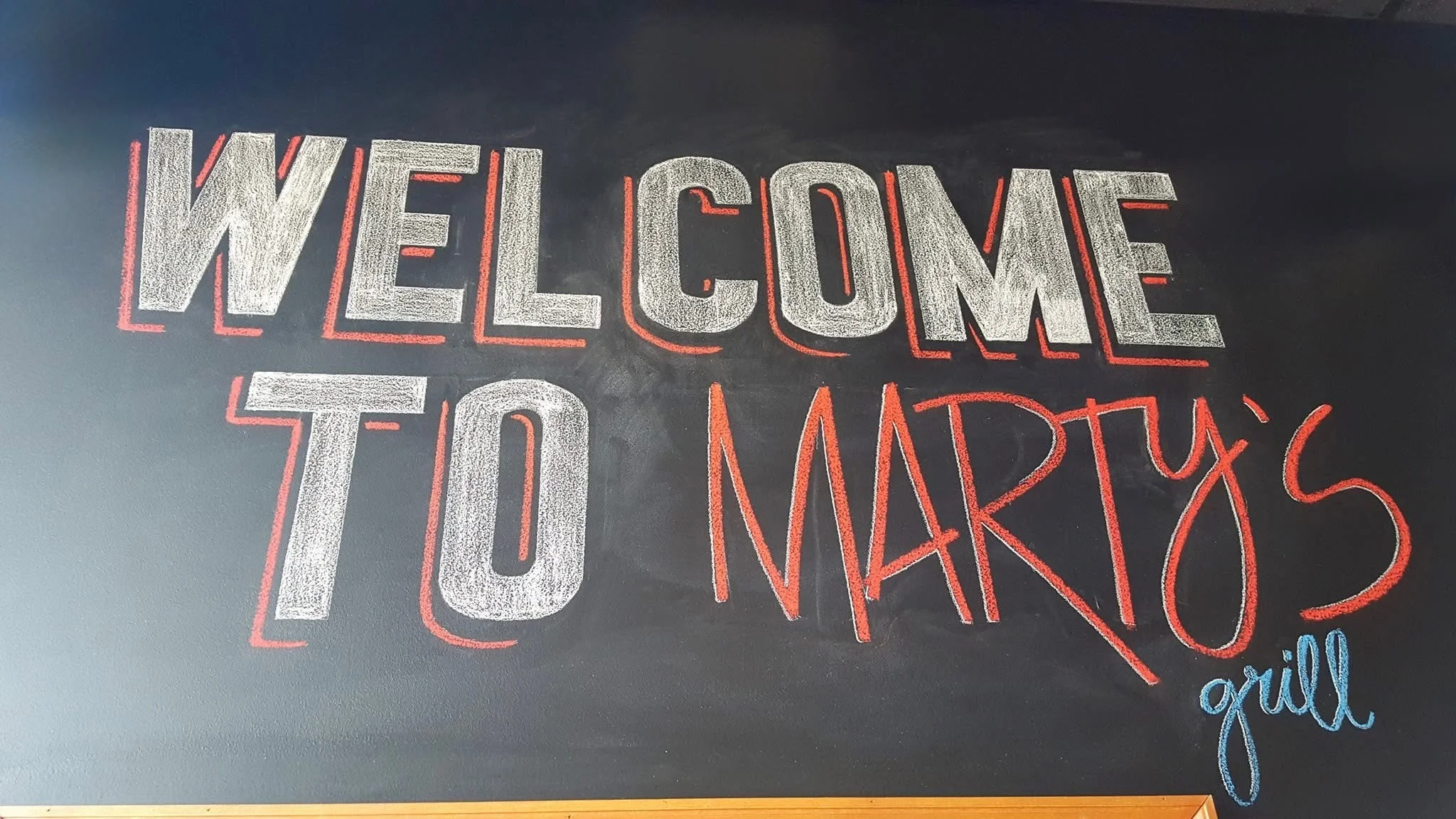 Exterior view of Marty's Grill restaurant with modern signage
