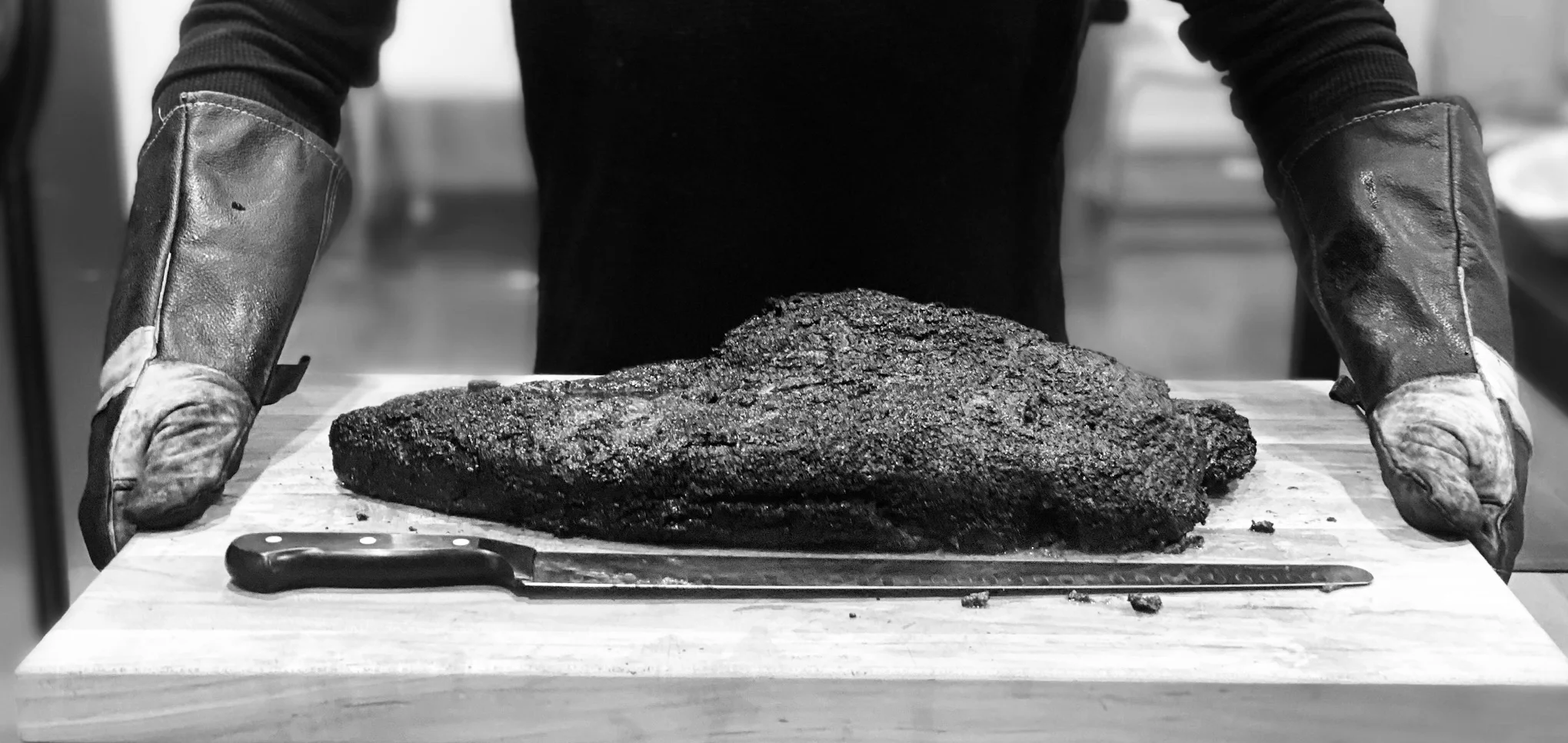 Smoked brisket served on a wooden cutting board