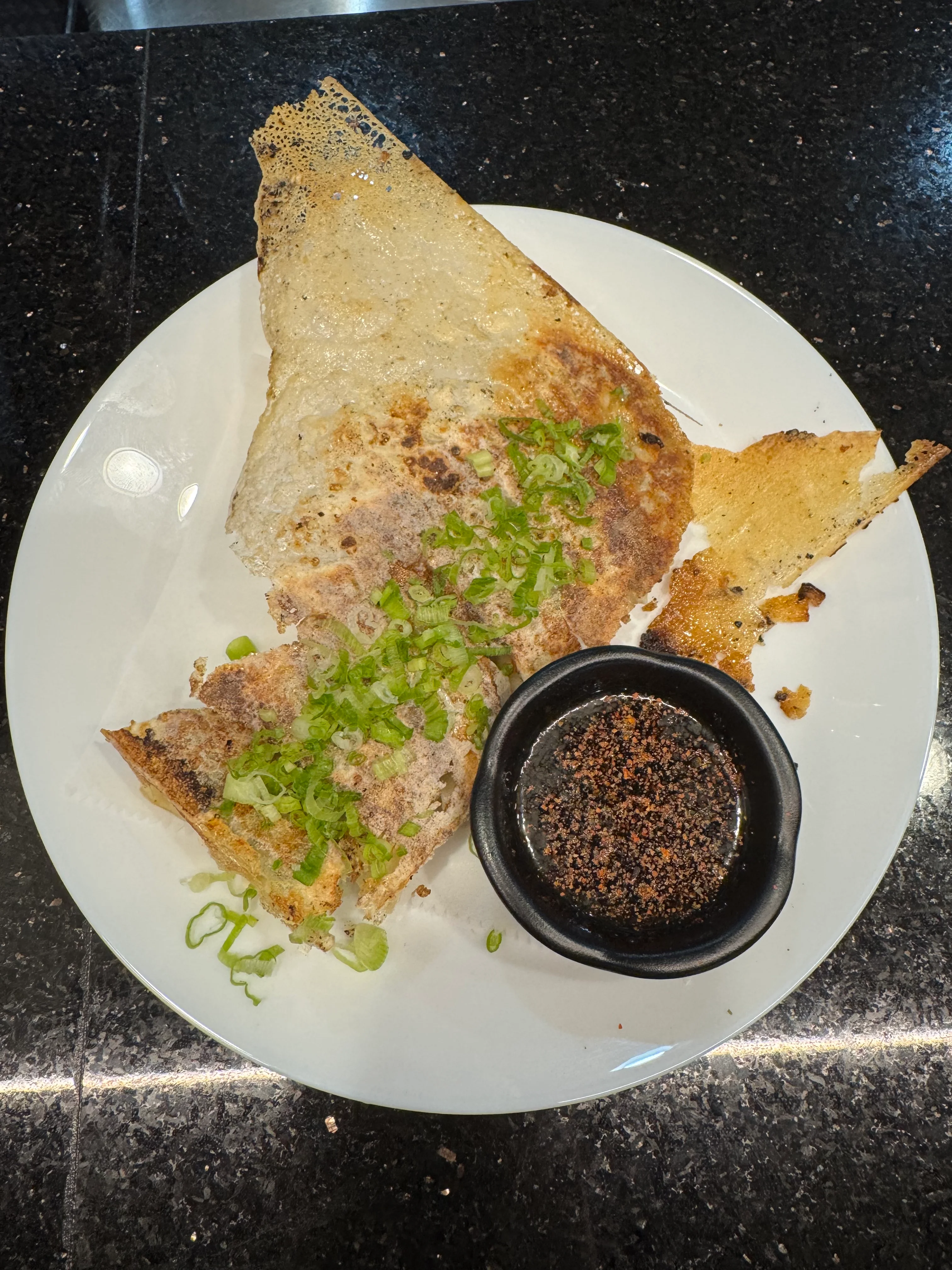Crispy South Indian dosa with green onions and dipping sauce