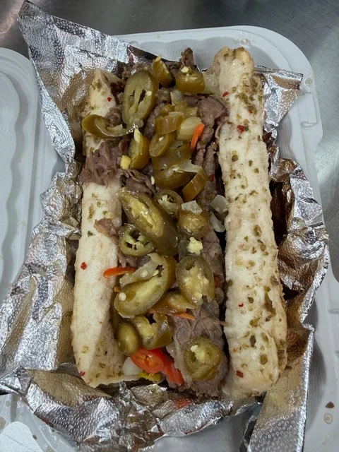Delicious gourmet burger with fresh toppings on a wooden table.