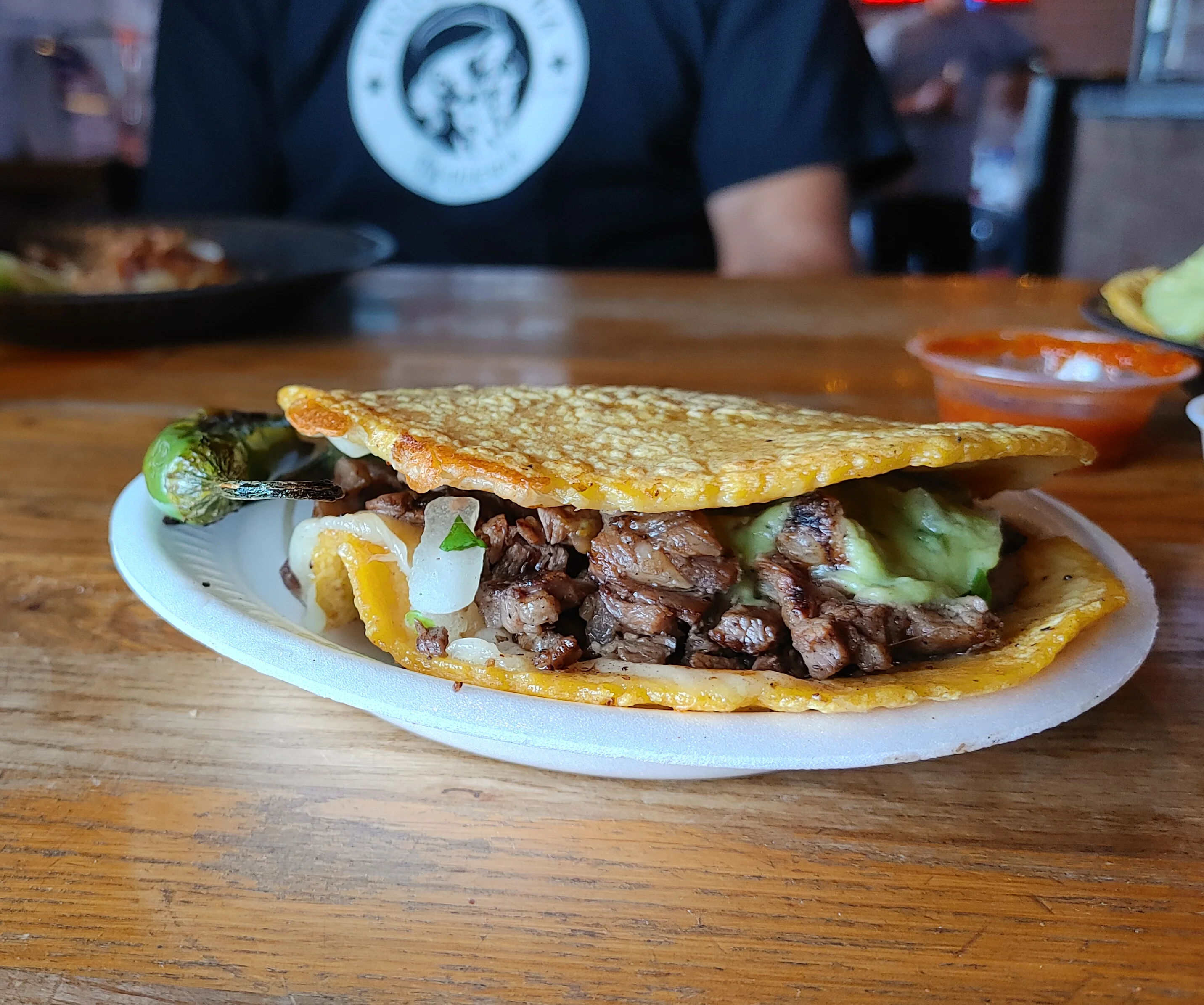 A mulita sitting on a table in Tacos Tijuana