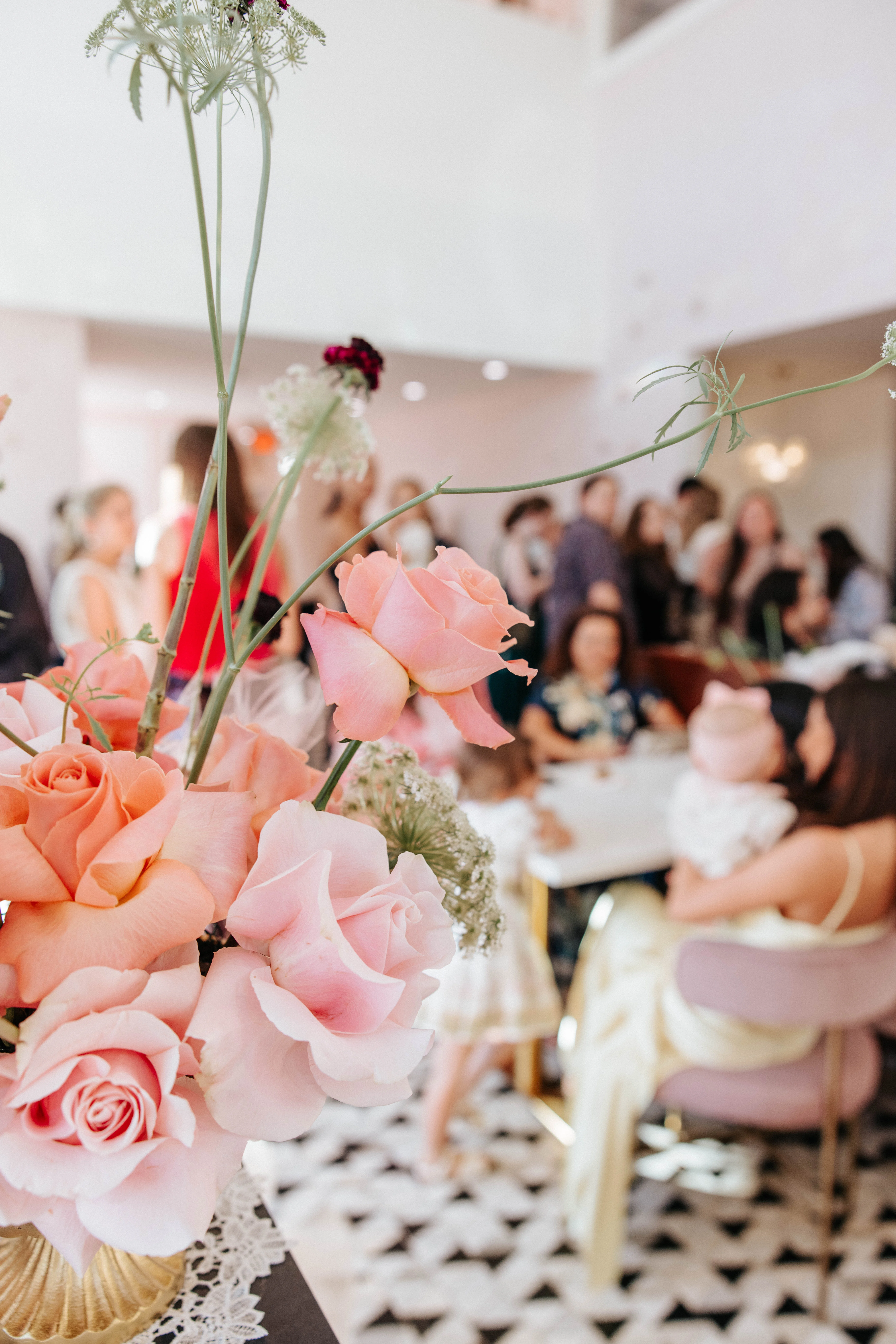 Elegant floral arrangement in a lively restaurant setting