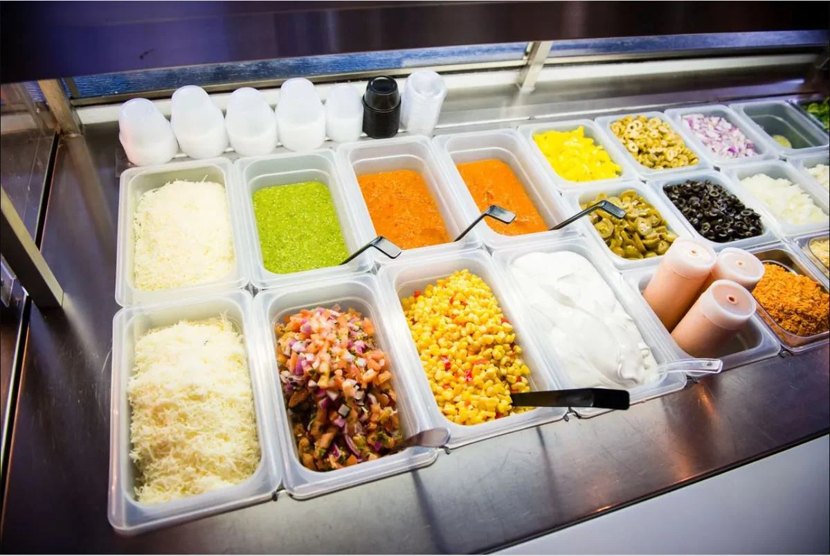 Colorful toppings for Mexican tacos at a food counter