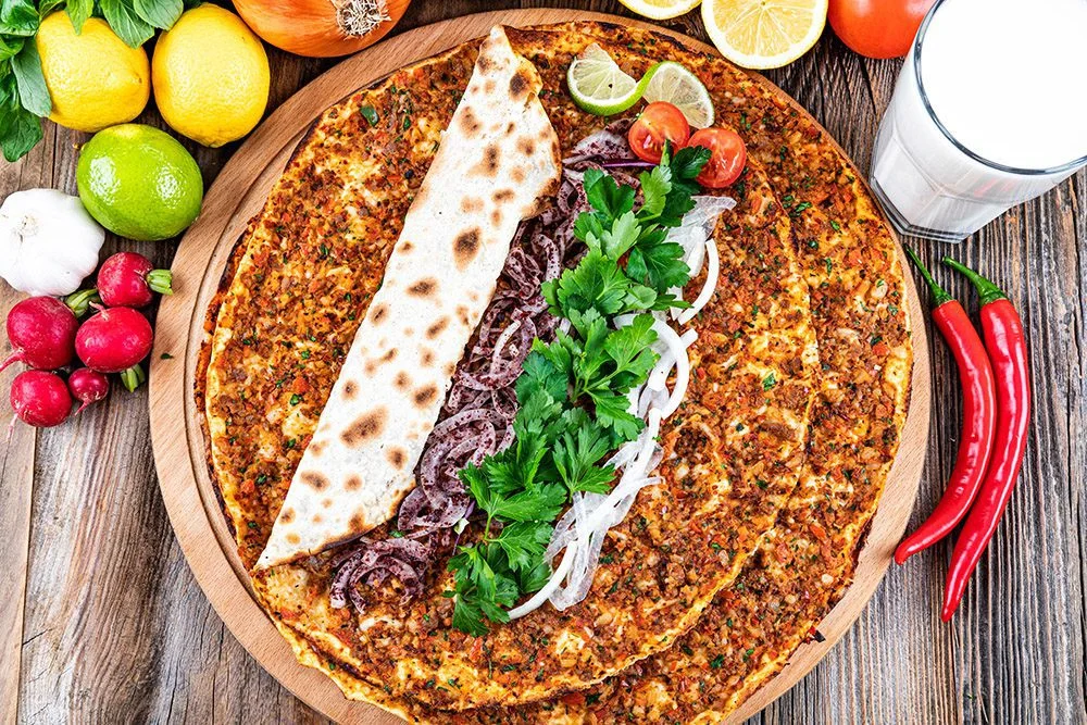 Turkish lahmacun with fresh herbs and toppings