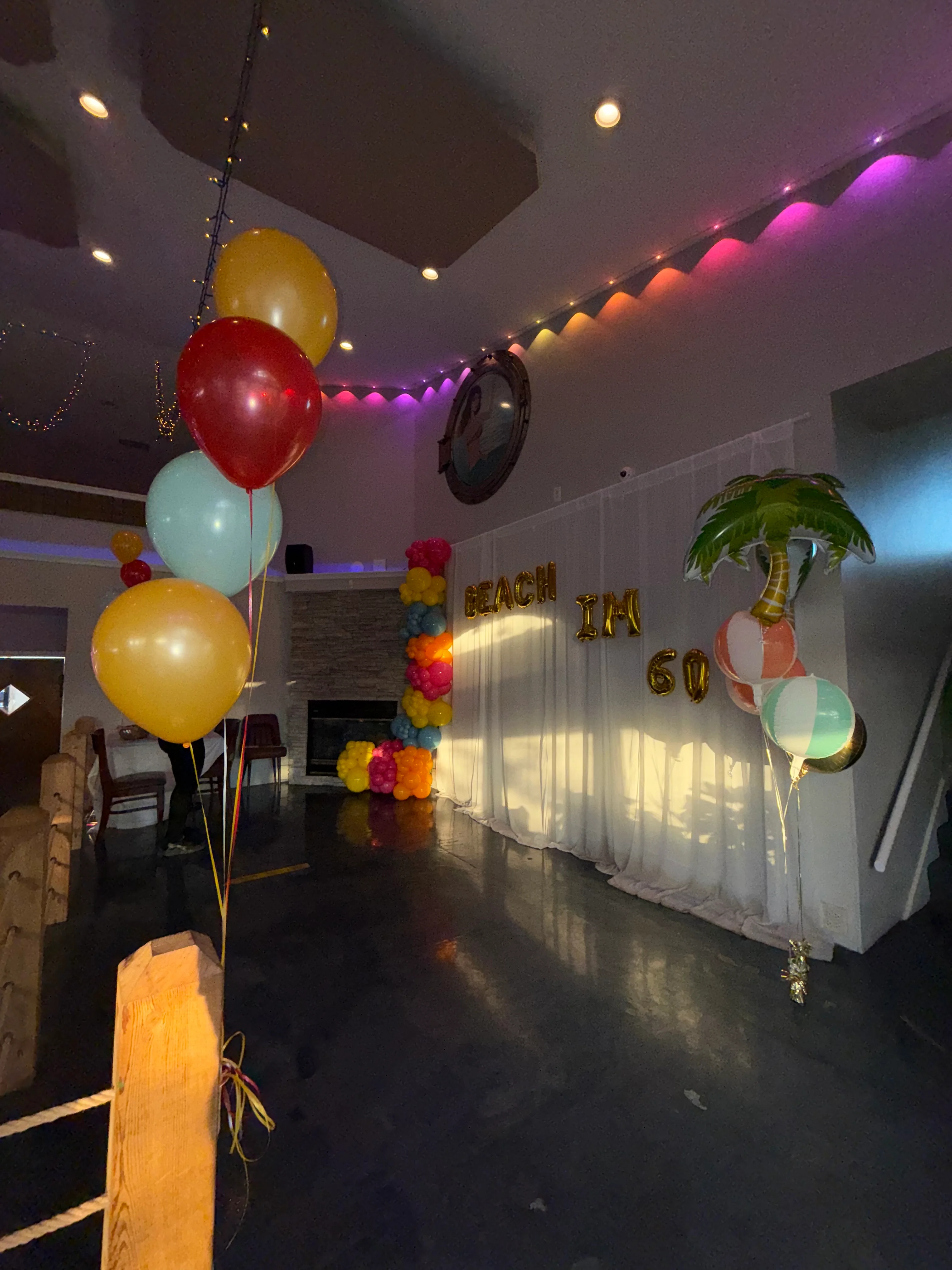 Colorful party decorations for a beach-themed 60th birthday celebration