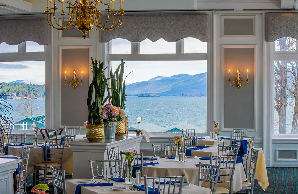 Elegant restaurant interior with lake view and floral decor
