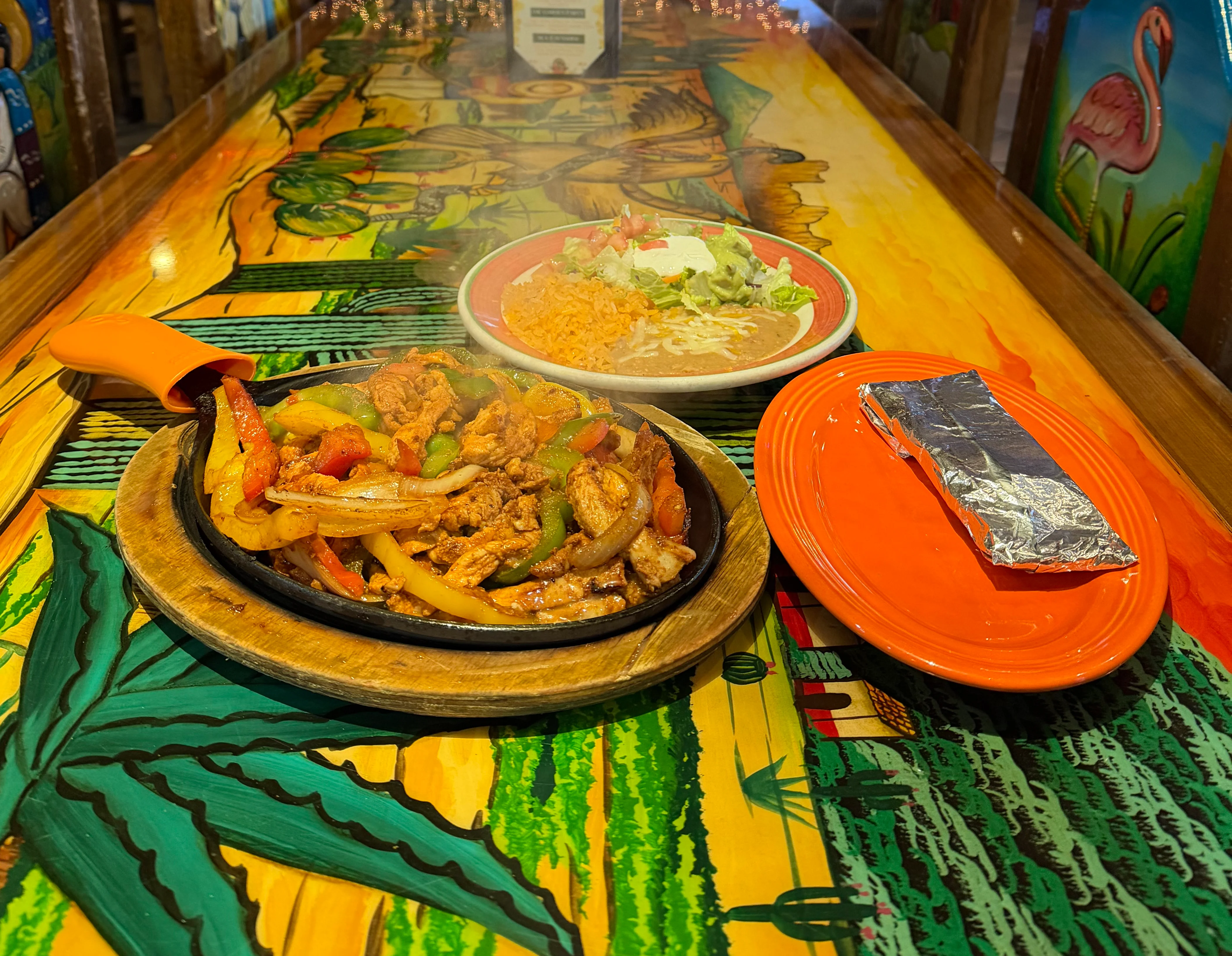 Delicious gourmet burger with fresh toppings on a wooden table.