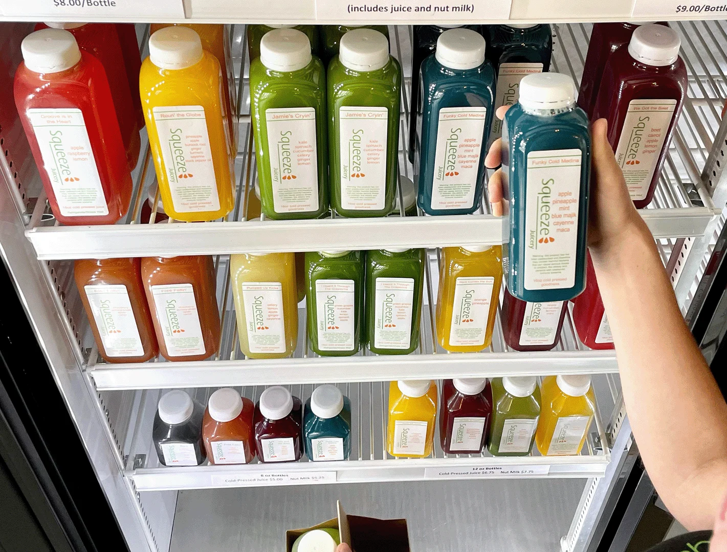 Colorful array of cold-pressed juices in a modern display