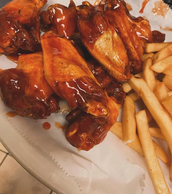 Crispy buffalo chicken wings with fries