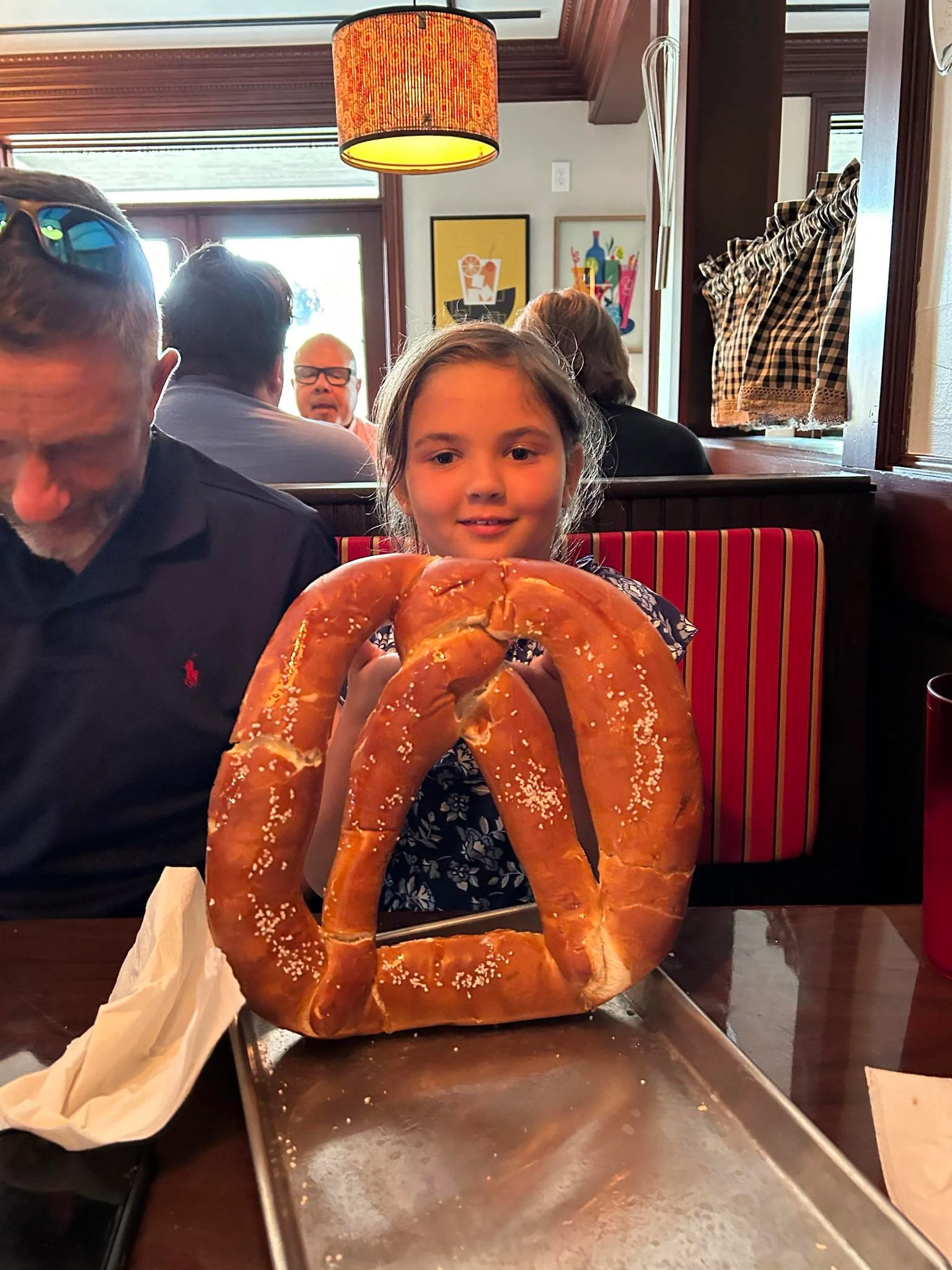 Giant soft pretzel served in a cozy restaurant setting