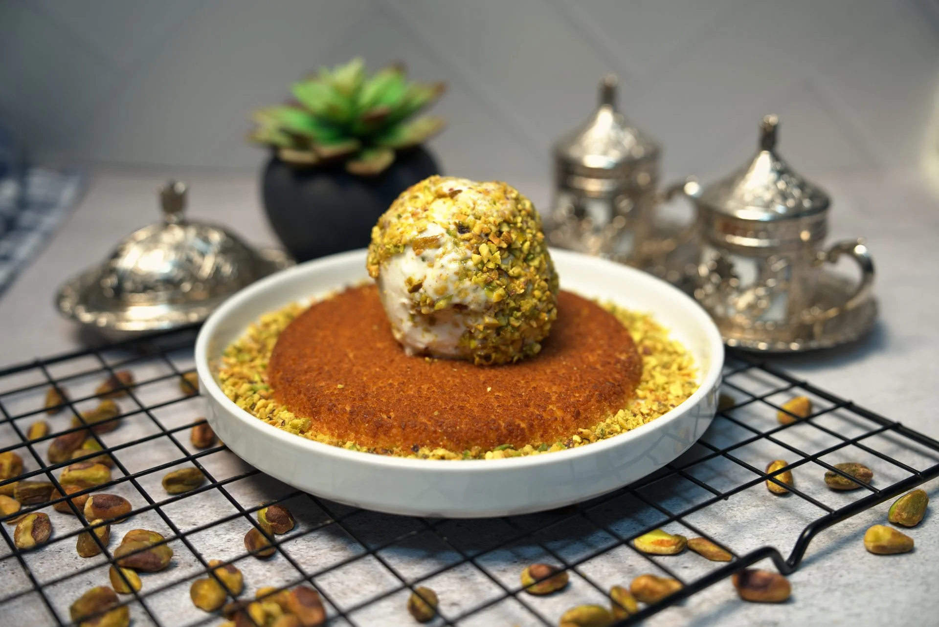 Middle Eastern pistachio kunafa topped with ice cream