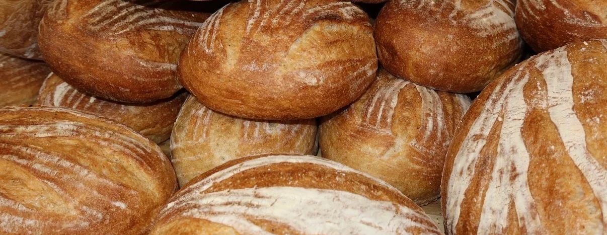 Freshly baked artisan bread rolls stacked