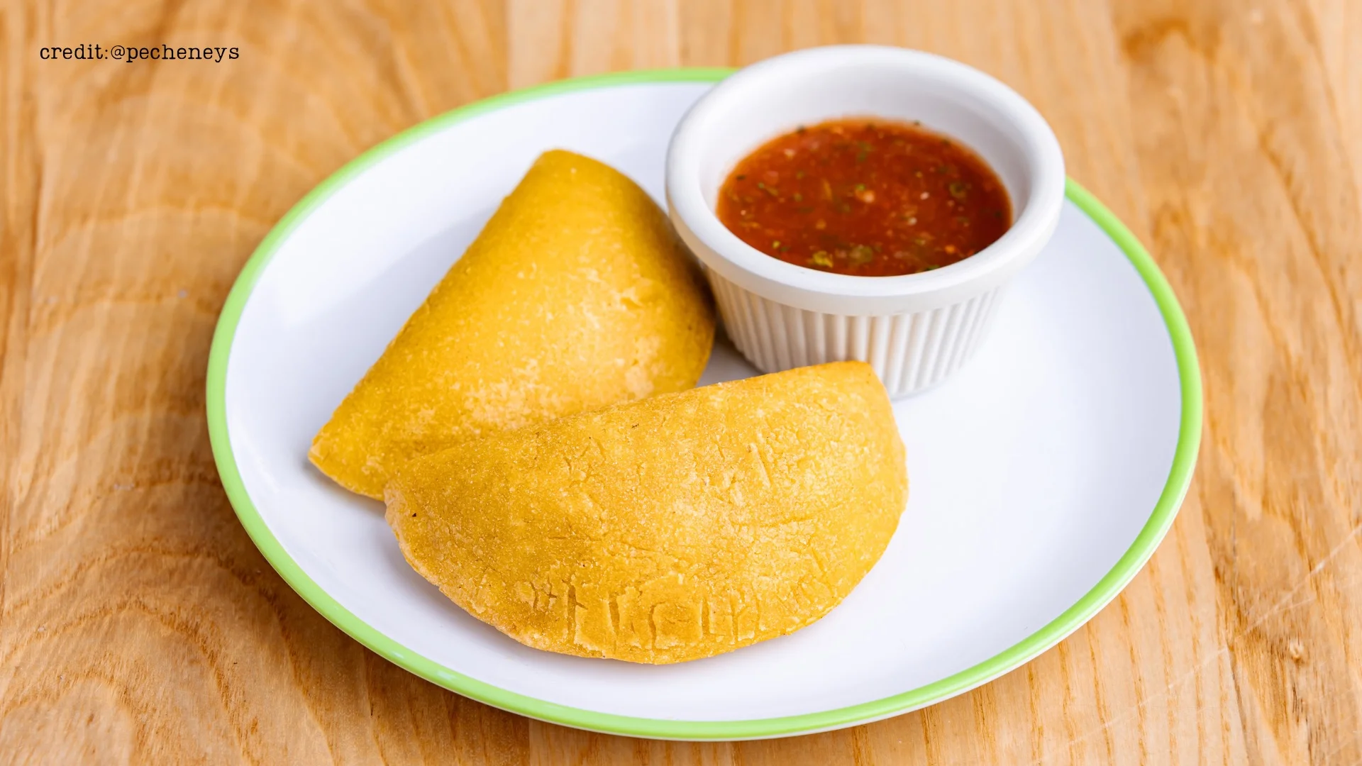 Golden empanadas served with spicy salsa